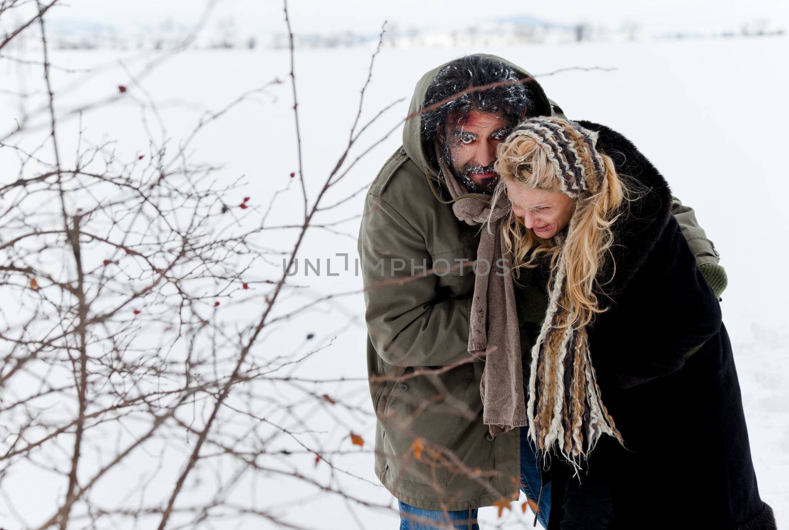 Frozen homeless couple struggling in winter time or kidnaping