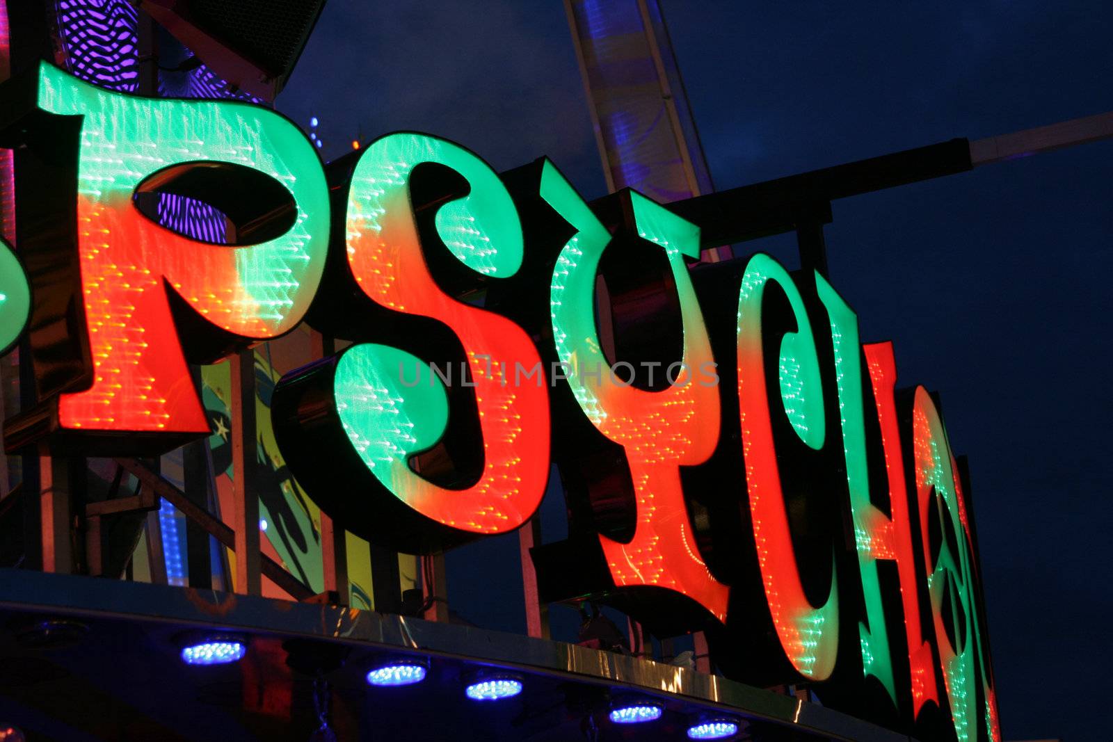 Neon fun fair attraction advertising at night