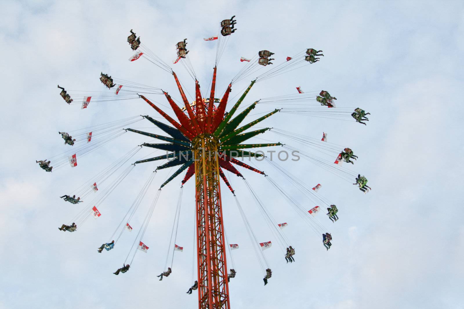 fun fair attraction chairoplane with cloudy sky