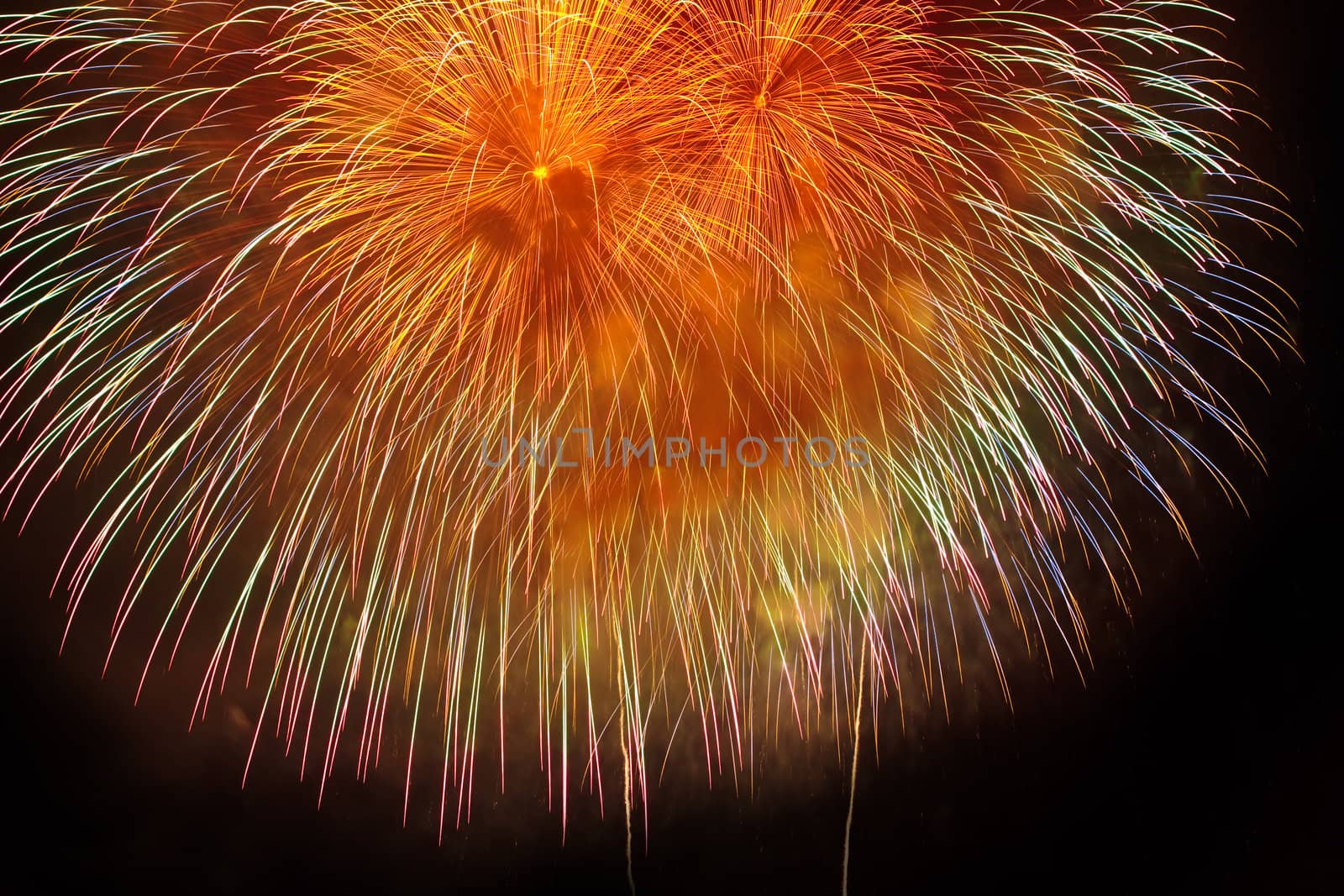 Colorful yellow and orange fireworks on  black sky