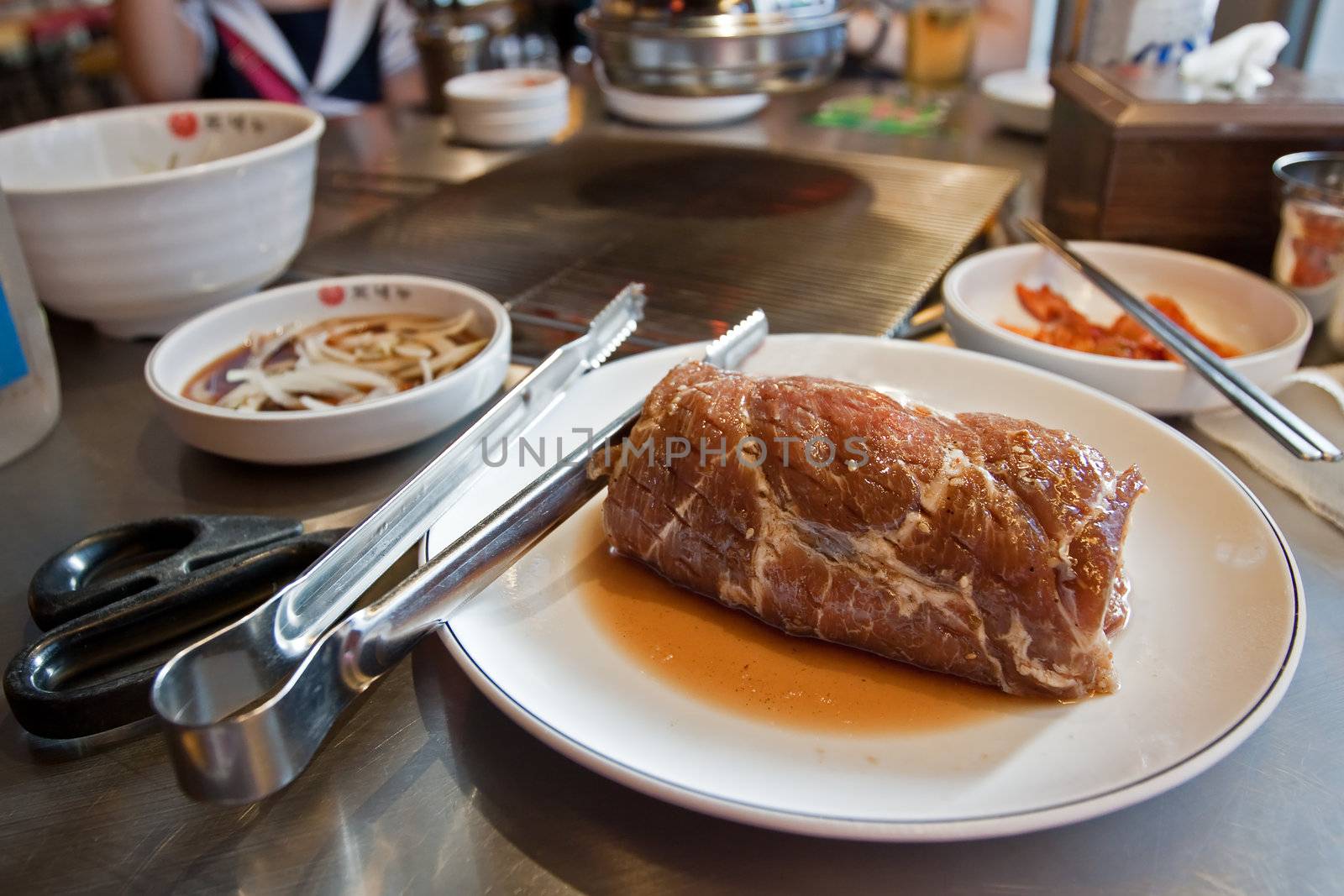 A piece of fresh beef for barbeque on a white plate by dsmsoft