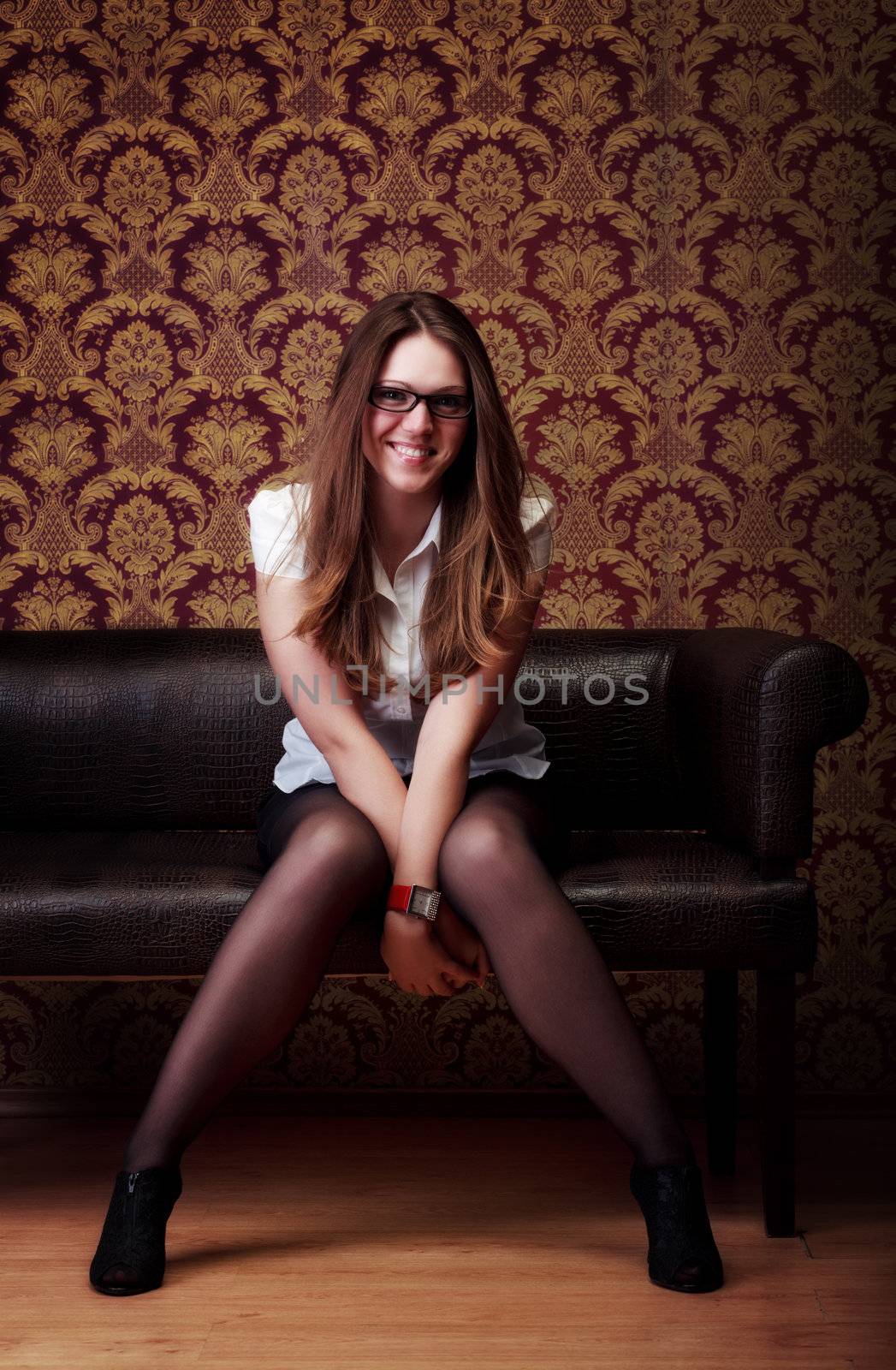 girl sitting on sofa by petr_malyshev