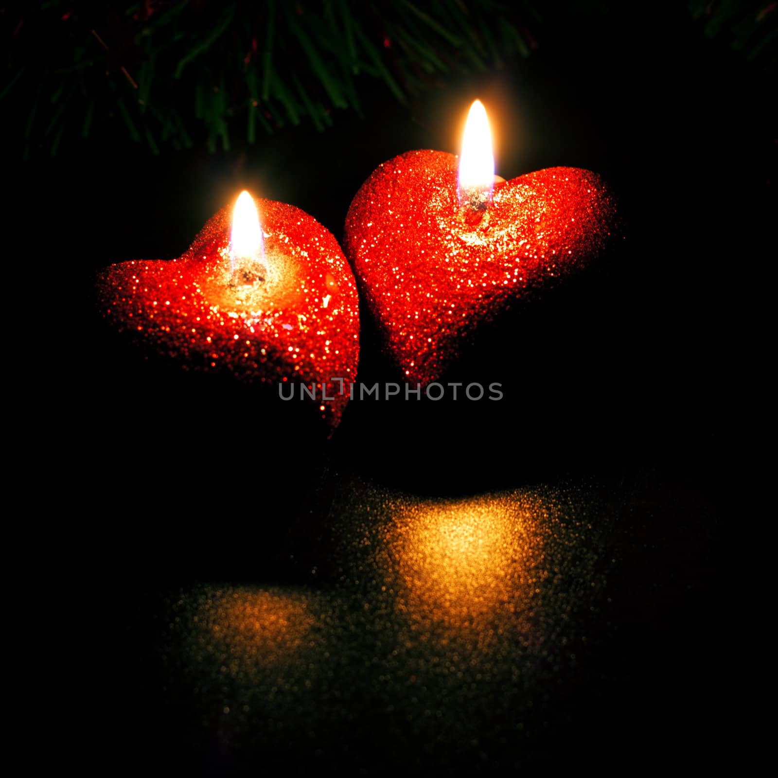 christmas card with two heart-shaped candles