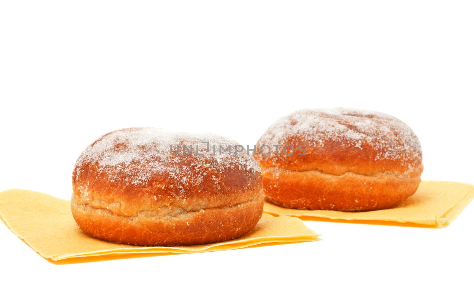 two donuts in powdered sugar on paper napkins
