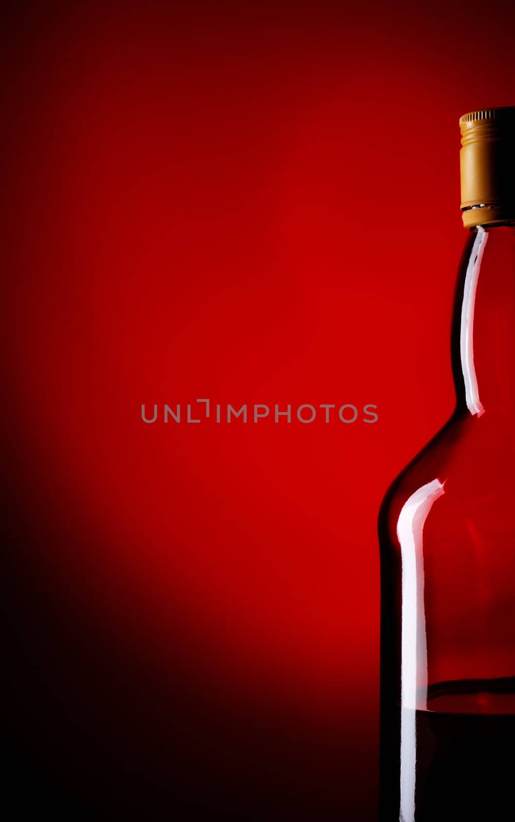 bottle of whiskey on red background