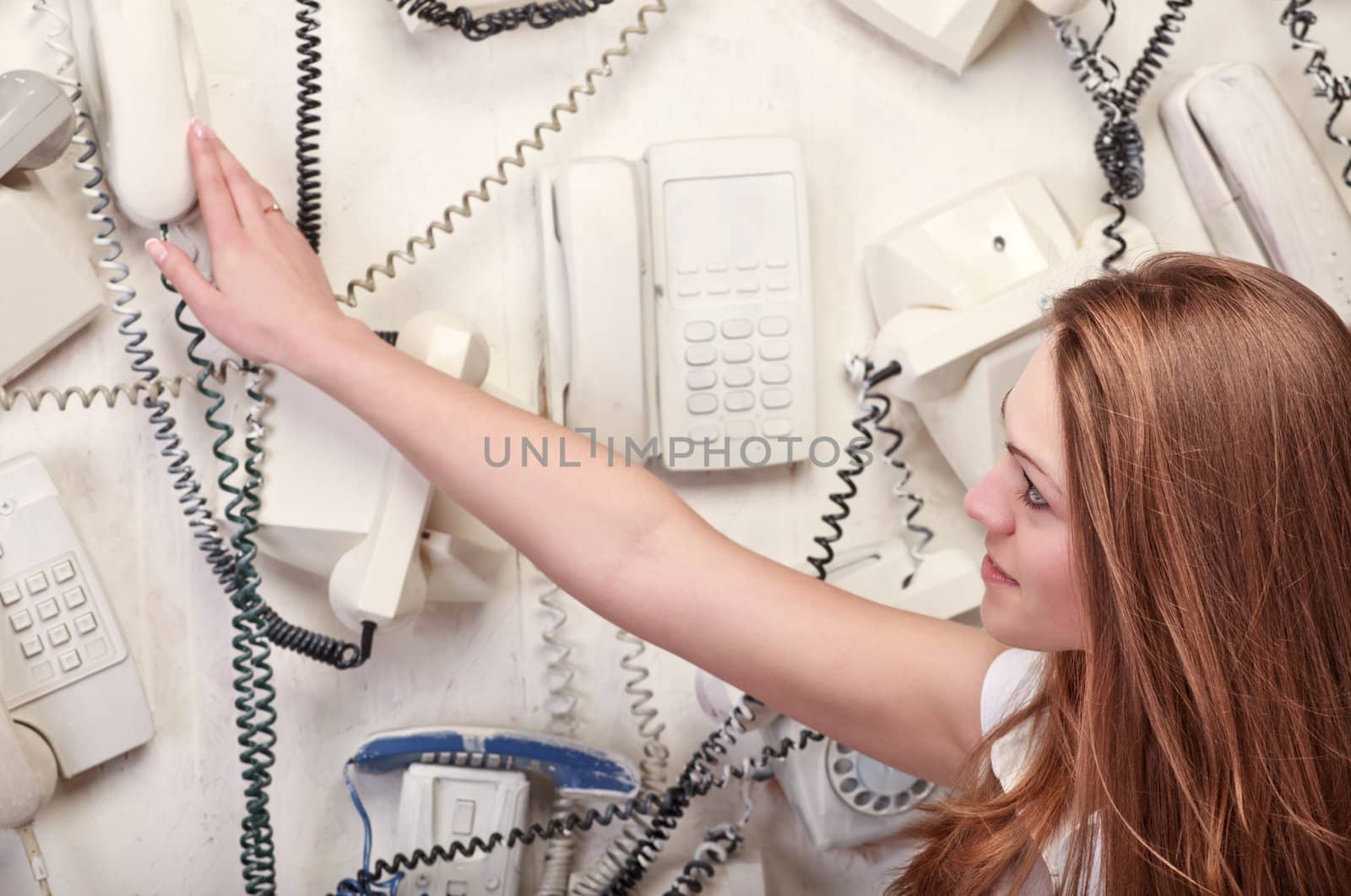 woman touching vintage phone on wall