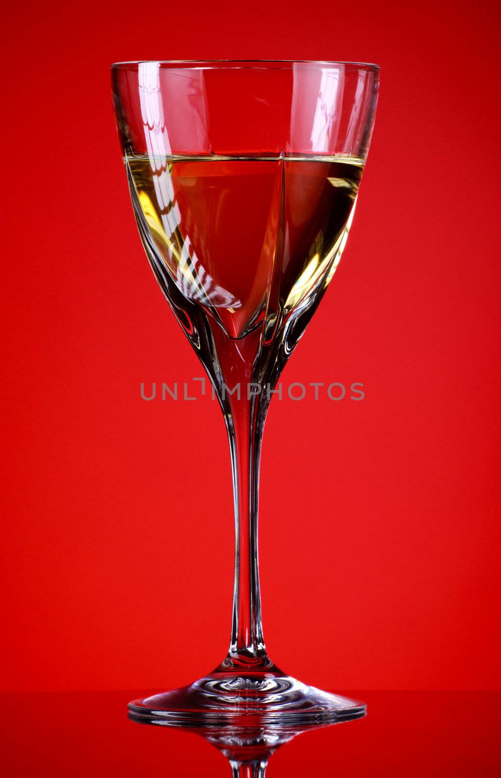  glass of white wine, red background