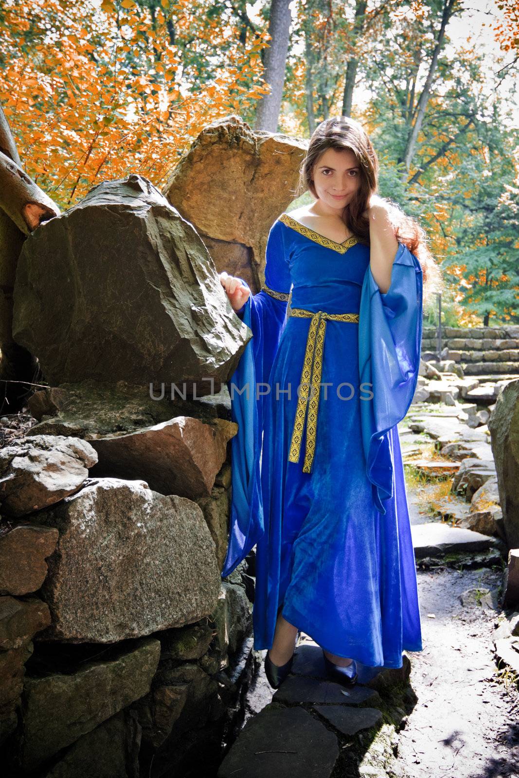 beautiful medieval princess in autumn stone garden