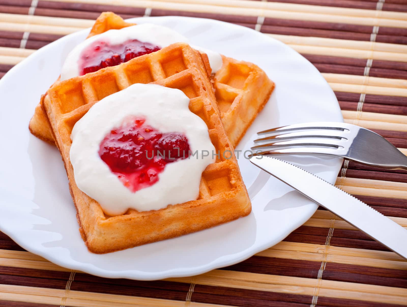 dessert with soft waffle, tea and raspberry jam