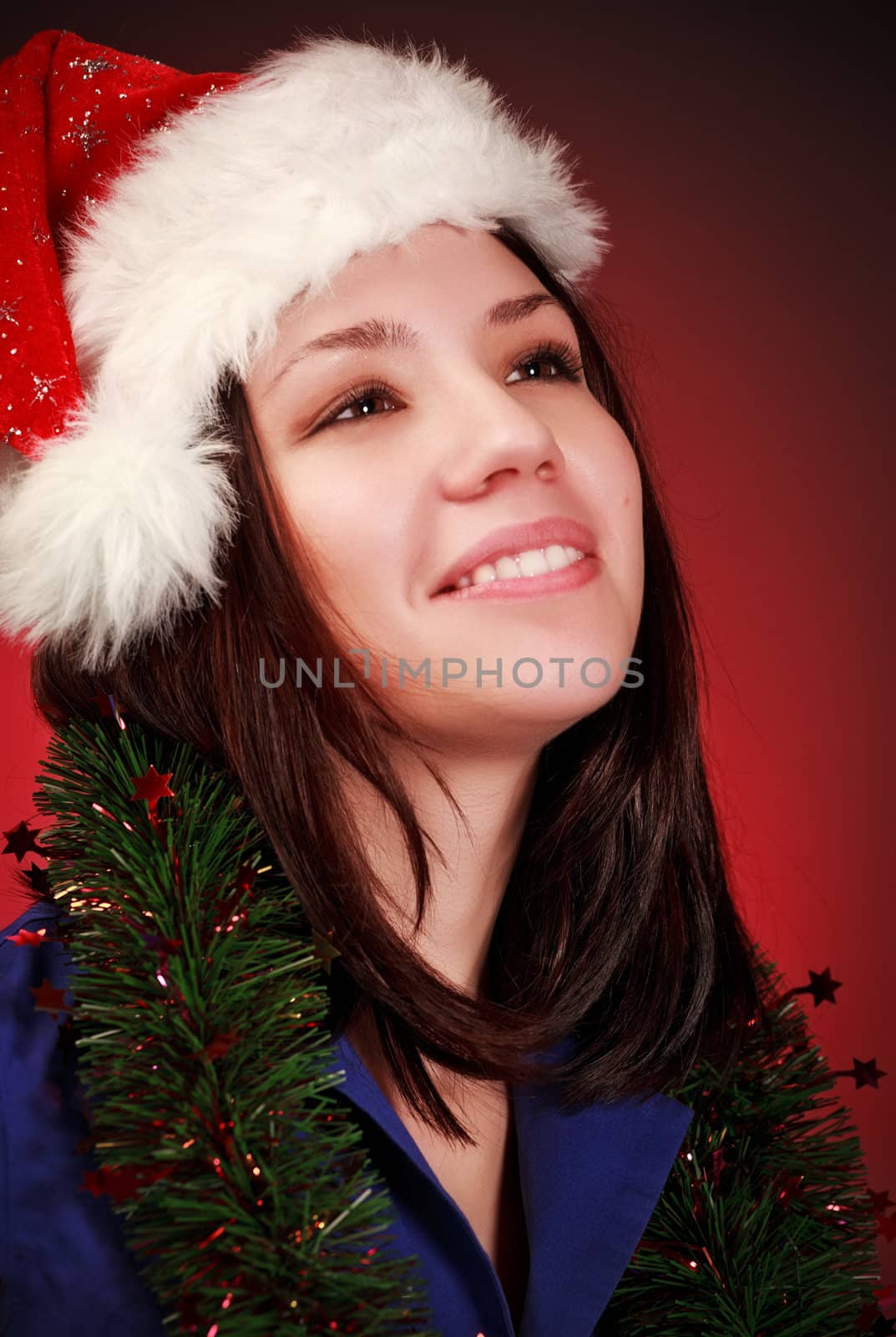 girl in santa hat portrait, red background