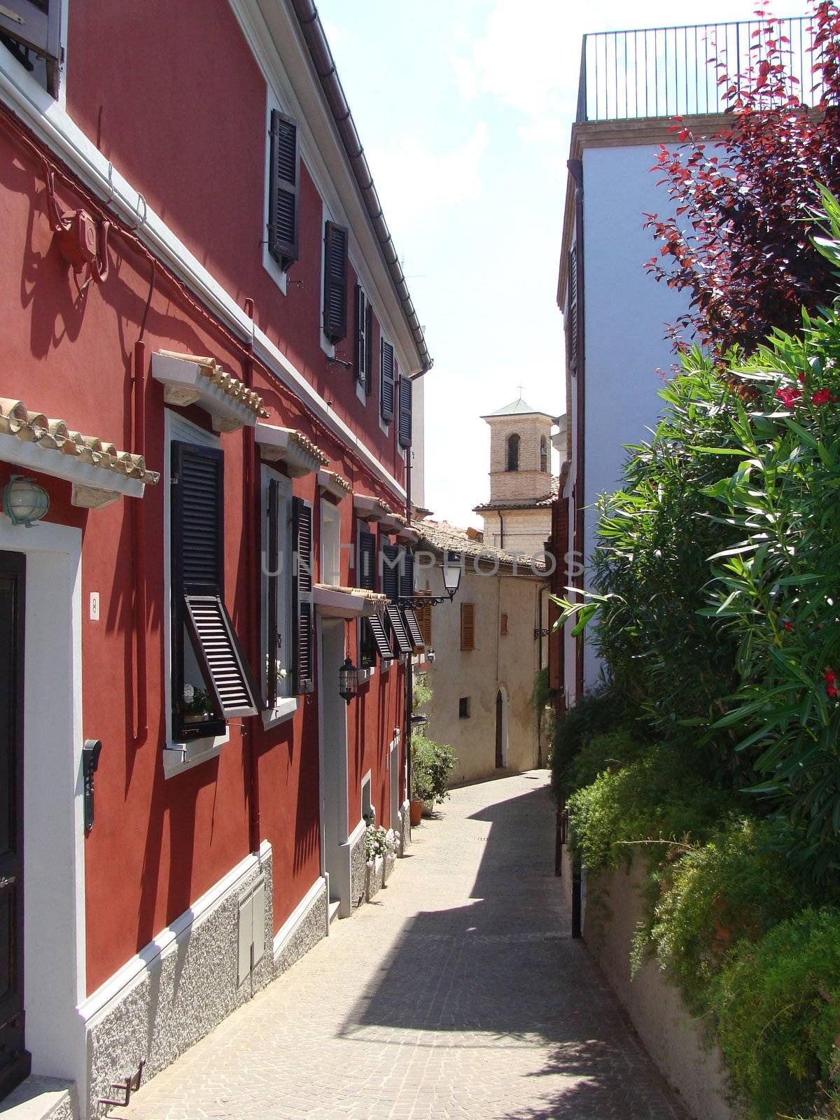 Narrow European street with the red house Italy