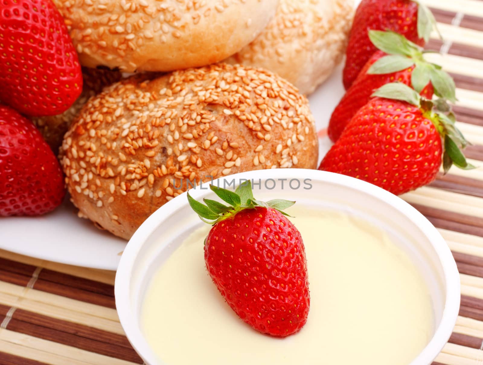breakfast with buns, strawberry and sour cream