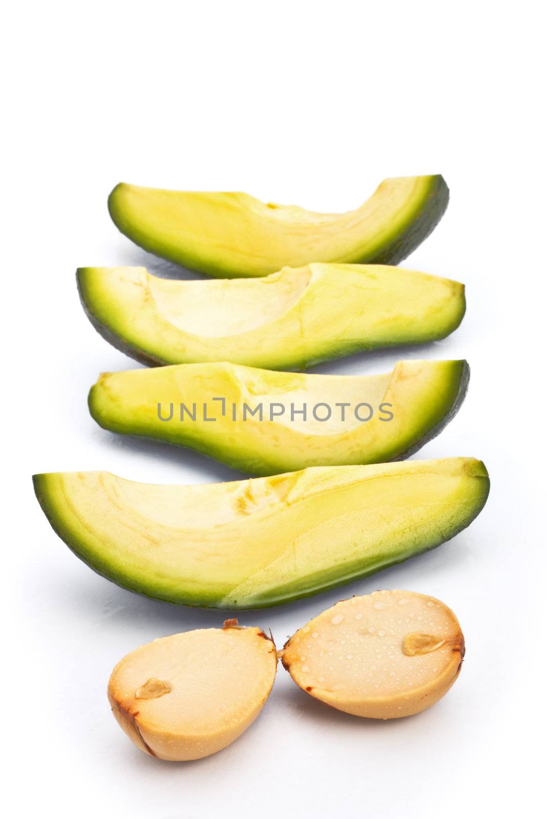 fresh avoсado slices and pips isolated on white