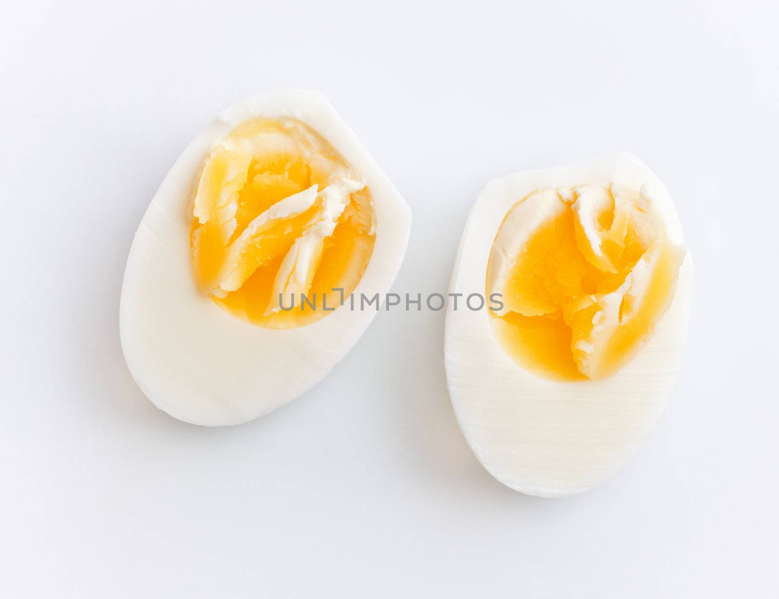 hard boiled egg sliced in half, gray background
