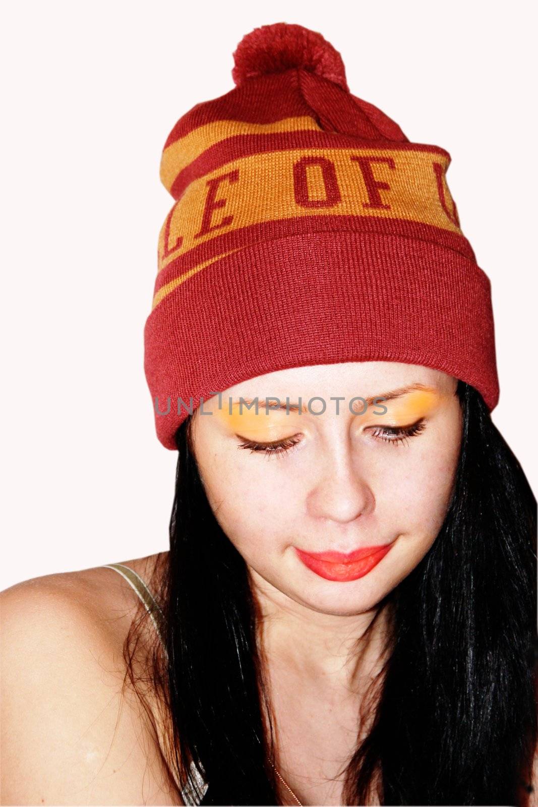 girl in a sports cap wiyh make-up thinking