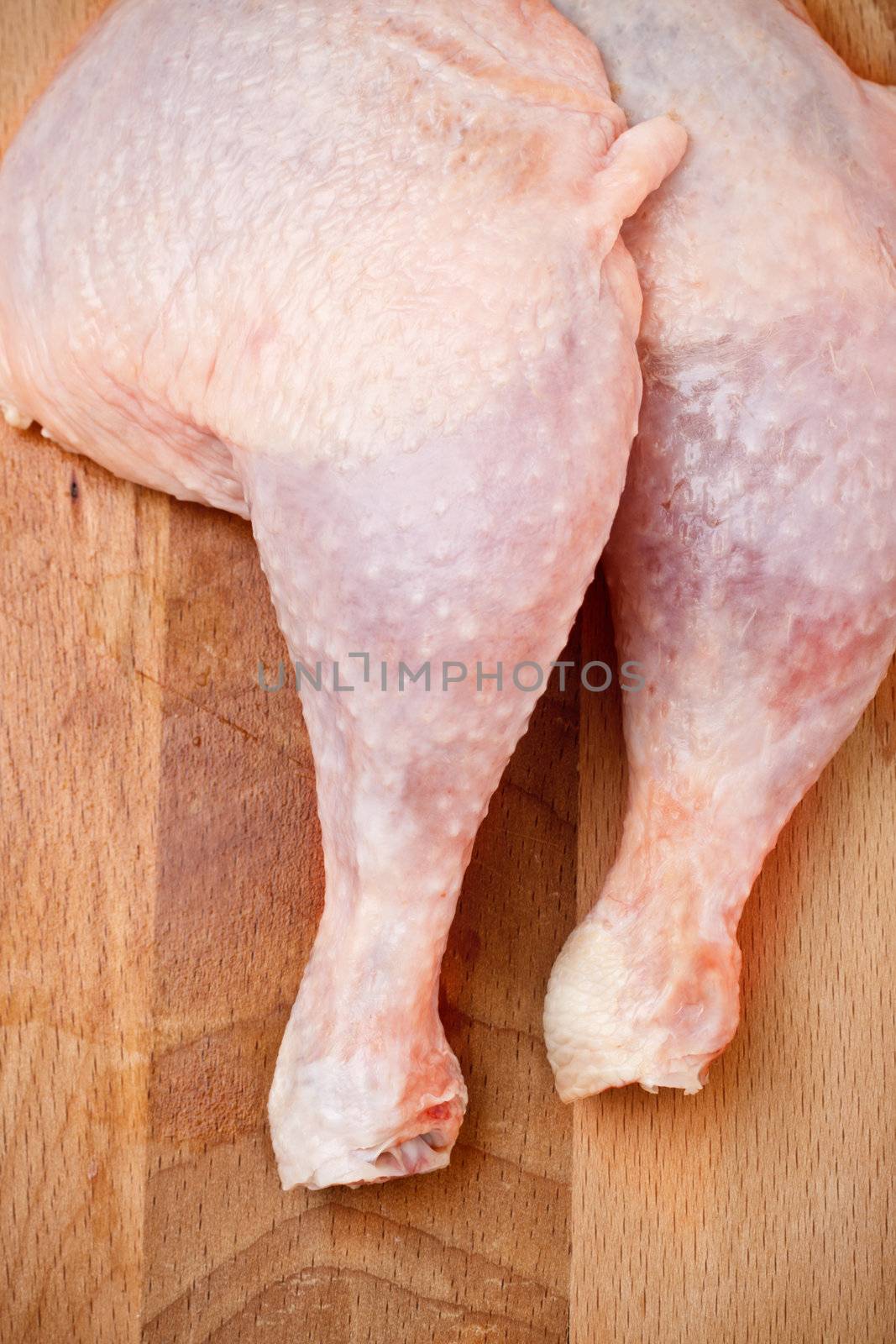 fresh chicken thighs laying on cutting board