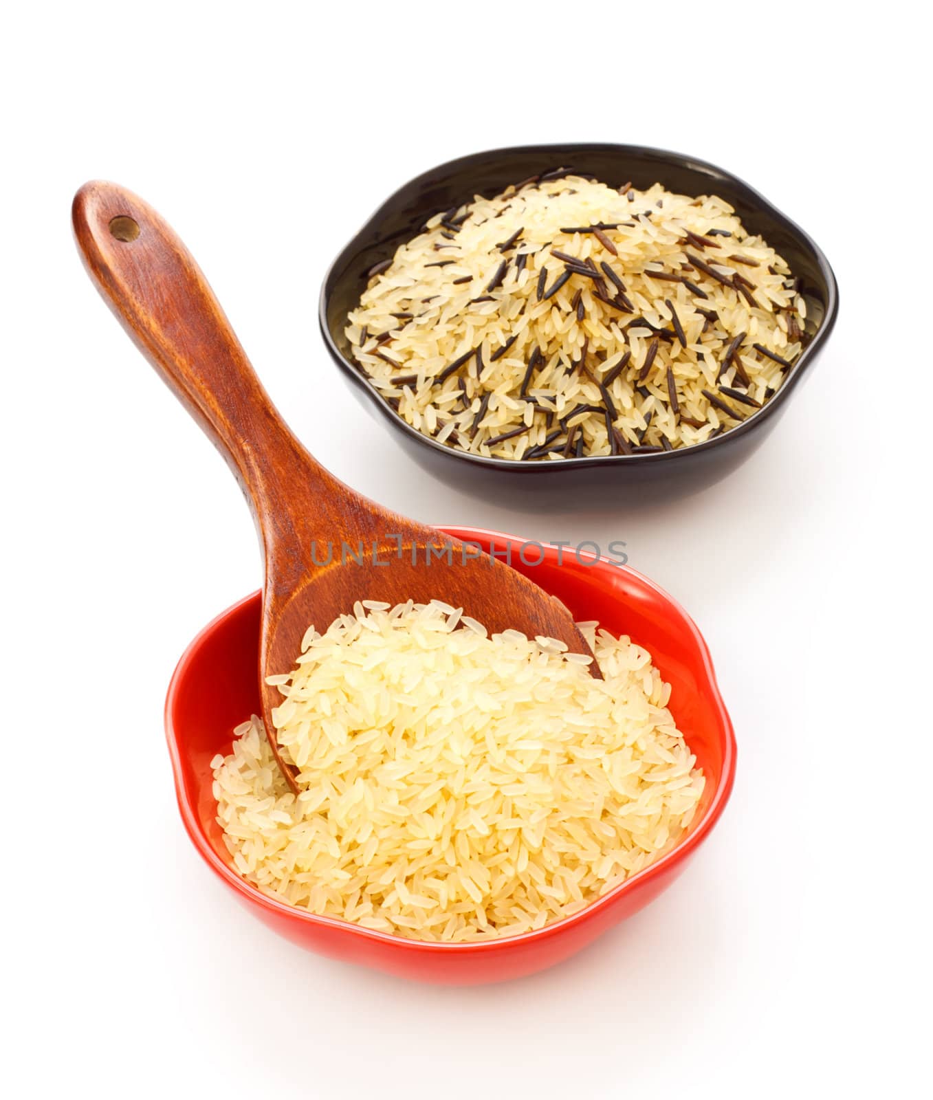 two bowls with rice and wooden spoon