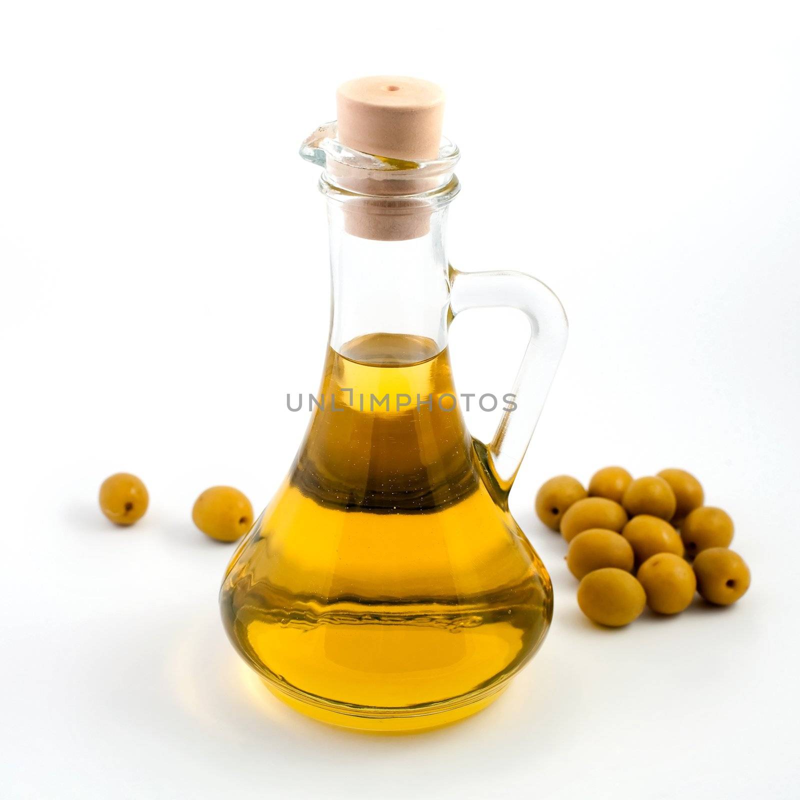 An image of green olives and bottle of oil 
