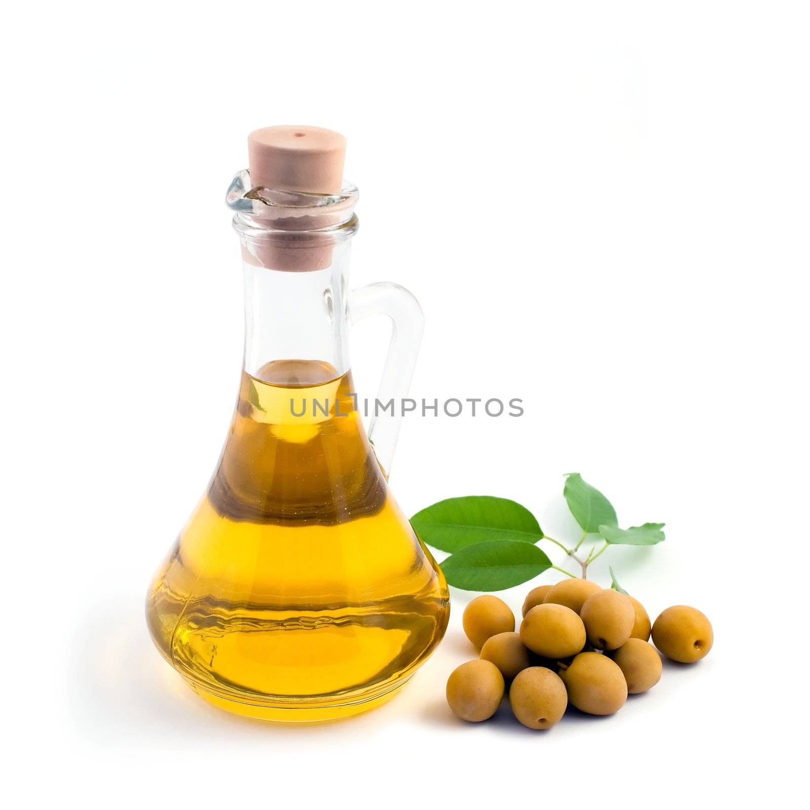 Green olives and bottle of oil on the table