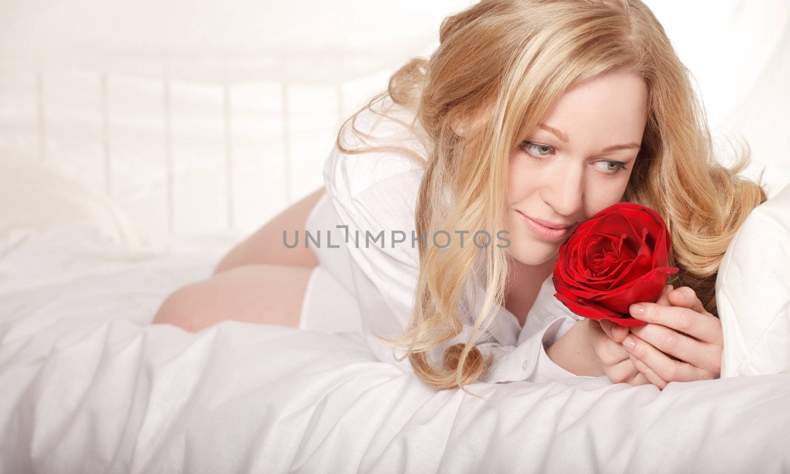 pretty girl in bed with red rose