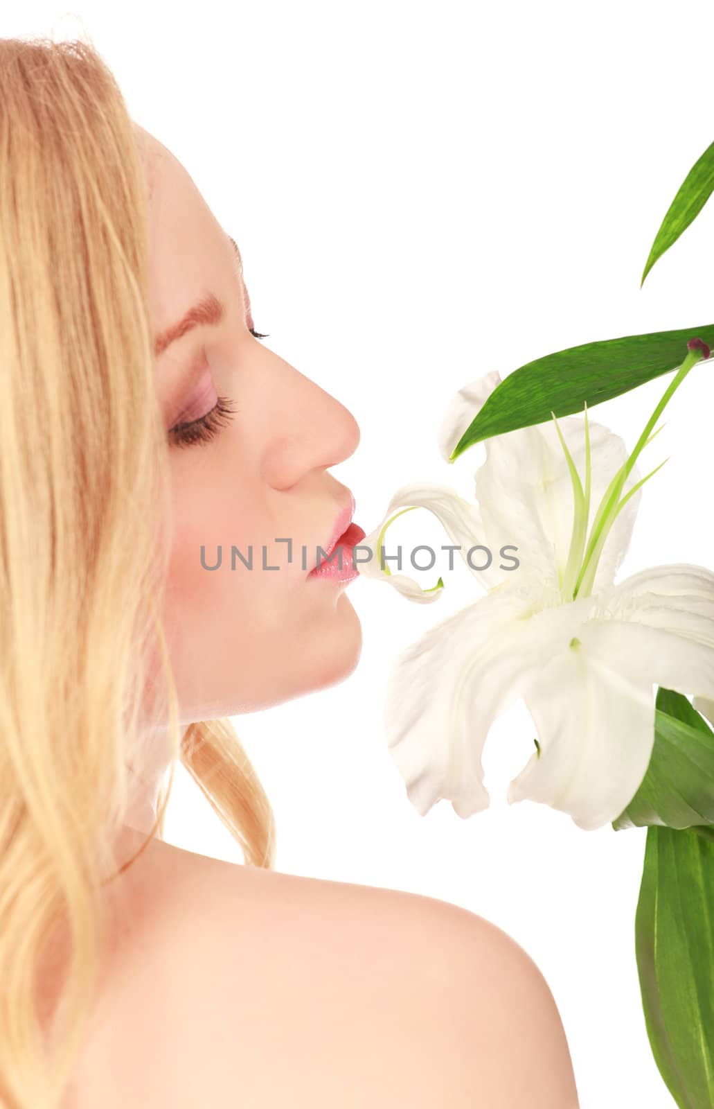 beautiful young woman kissing lily flower, close-up portrait