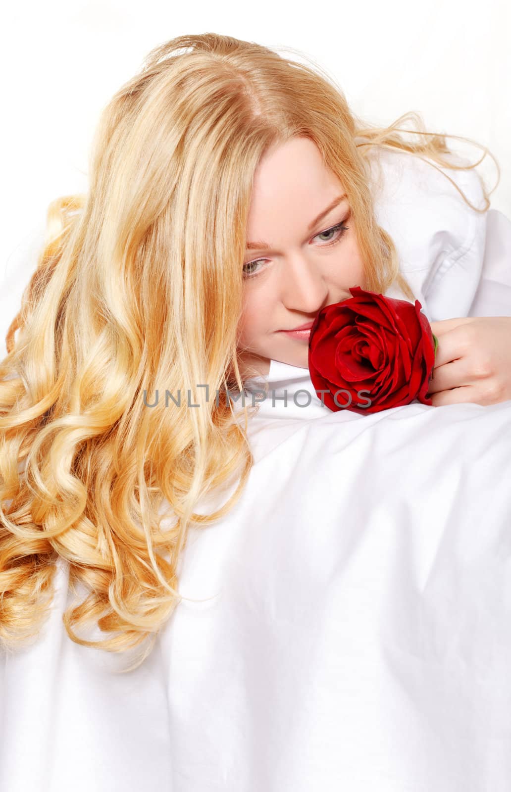 pretty blonde woman in bed with red rose