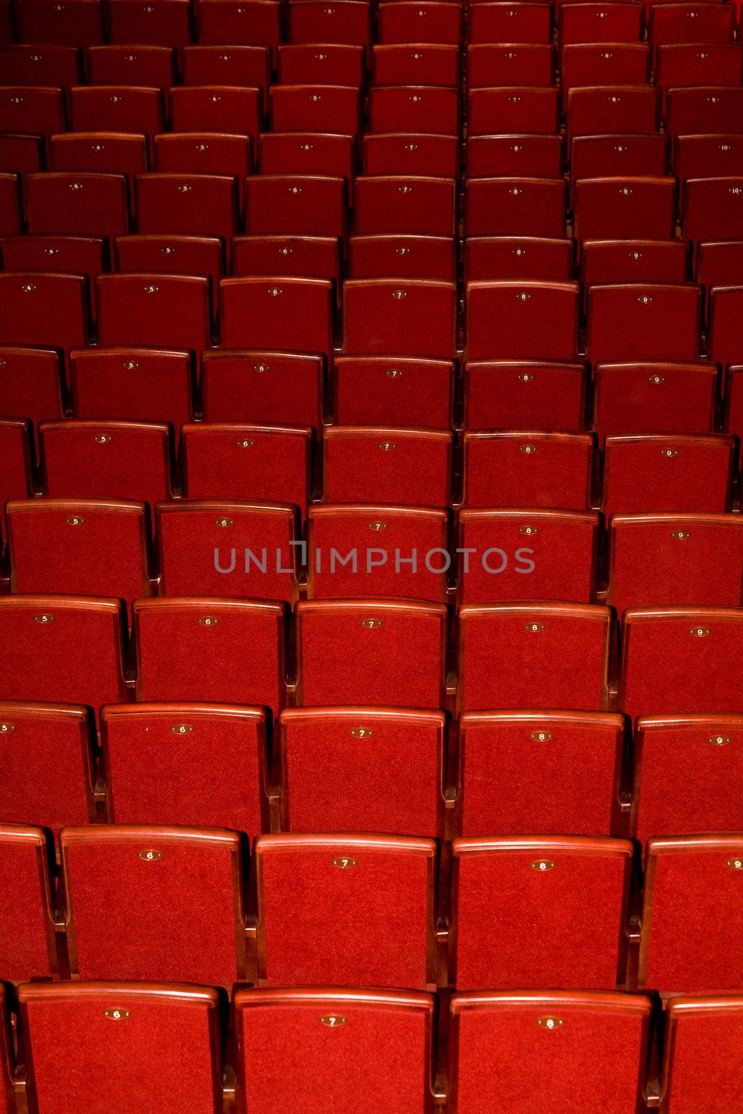 Stock photo: an image of rows of red chairs 