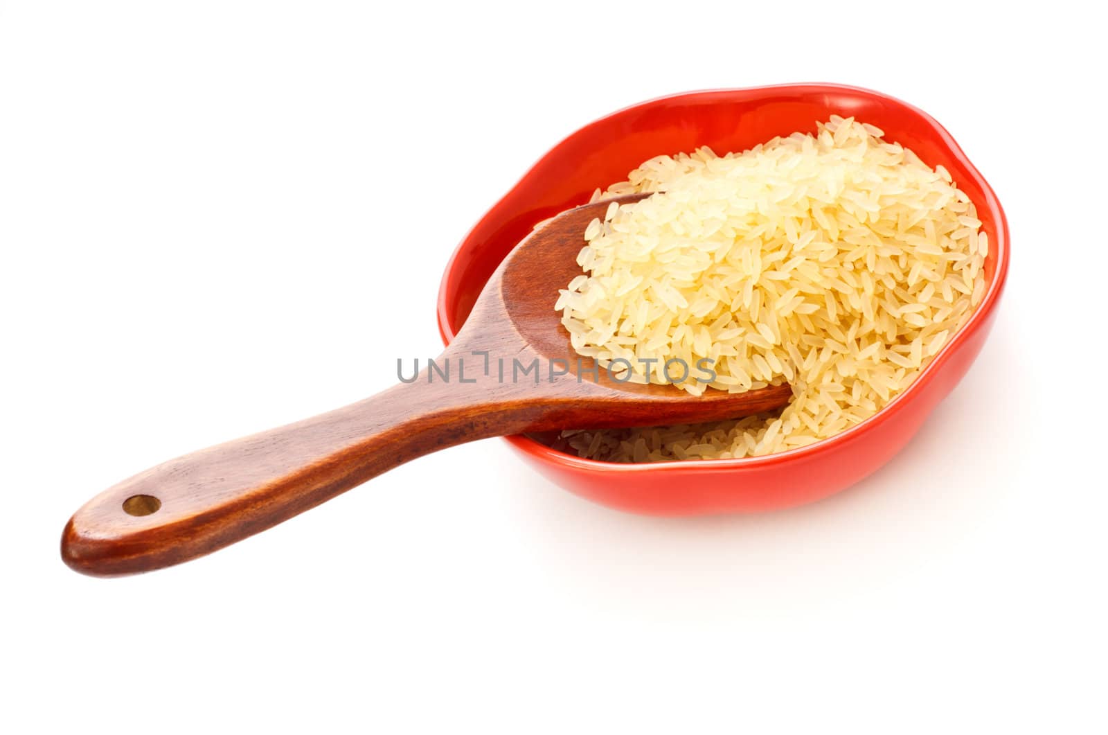 red bowl with rice and wooden spoon