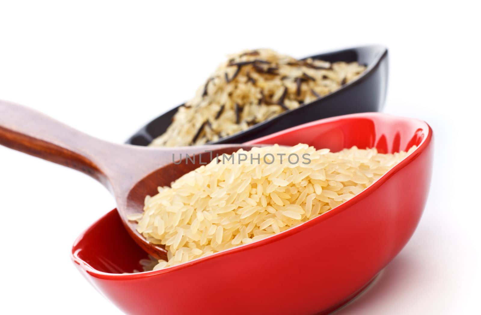 two bowls with rice and wooden spoon