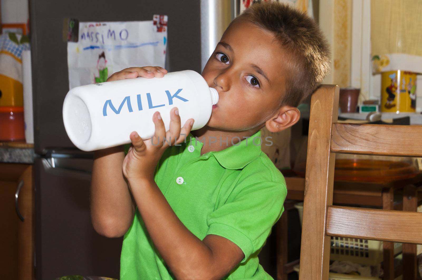 Little boy drinking milk.shot taken in the kitchen.