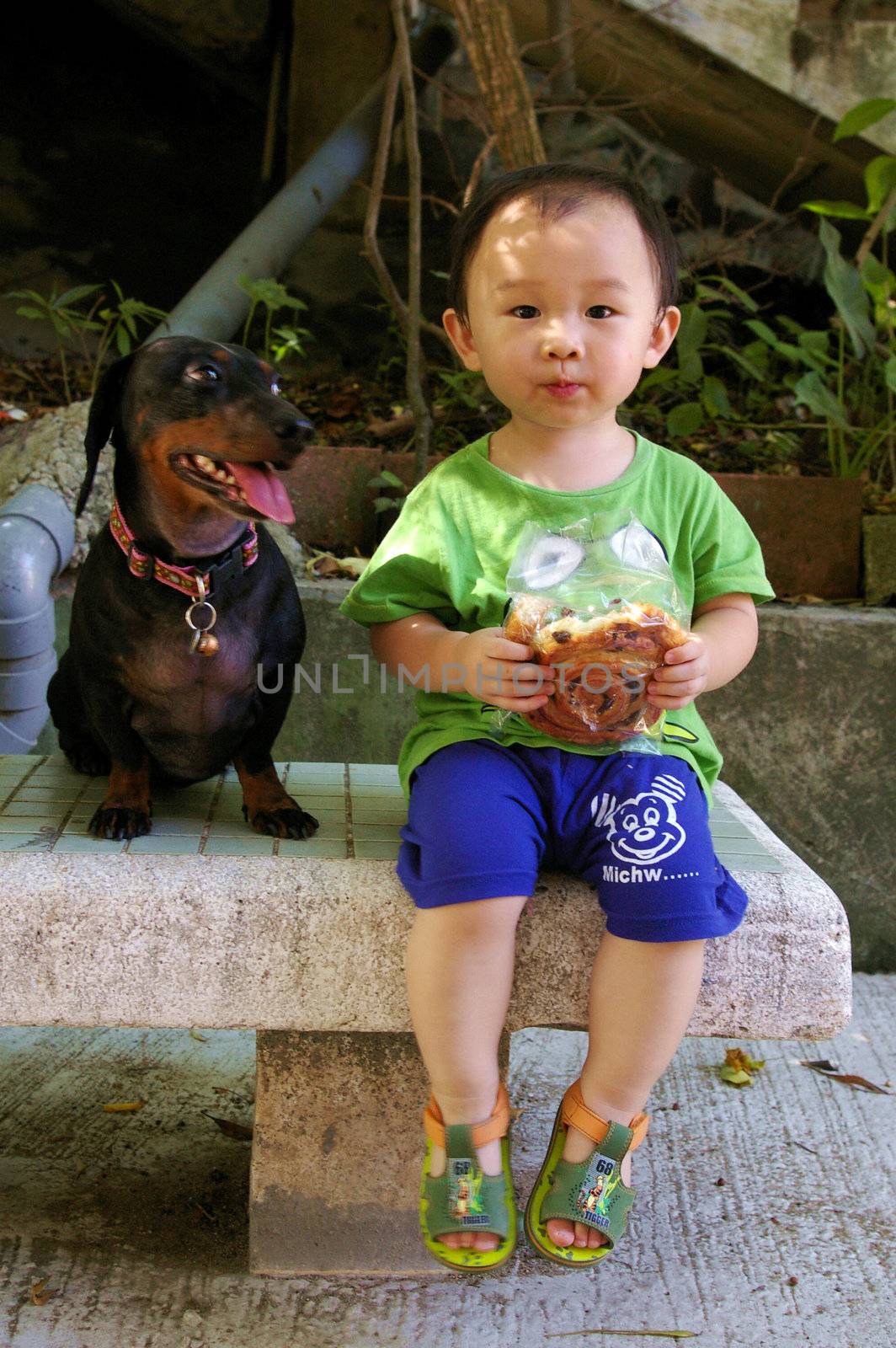 Young Chinese boy on street eating by kawing921