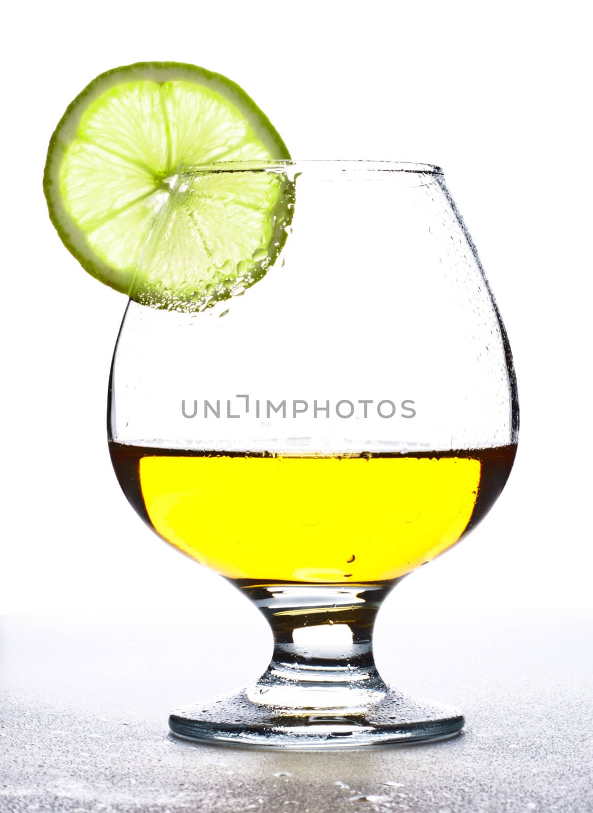 cocktail in glass with slice of lime