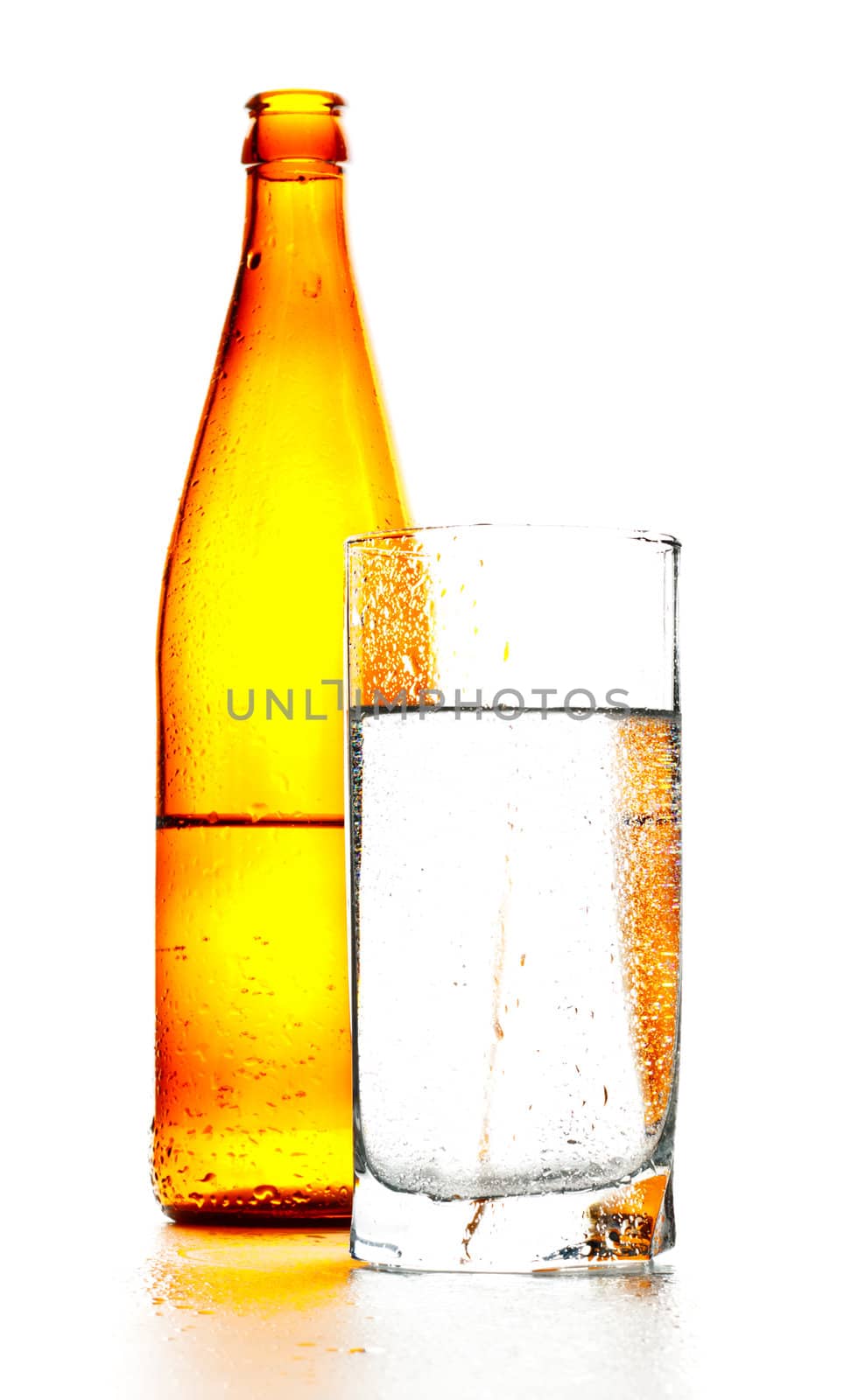 bottle of mineral water and glass isolated on white