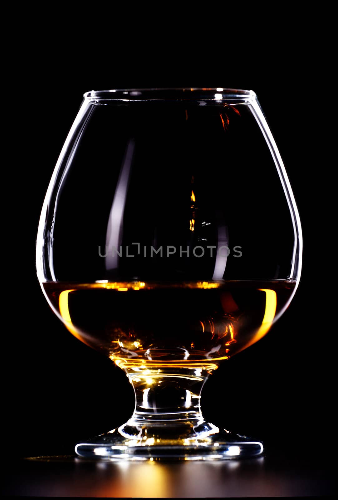 elegant whiskey glass isolated on black background