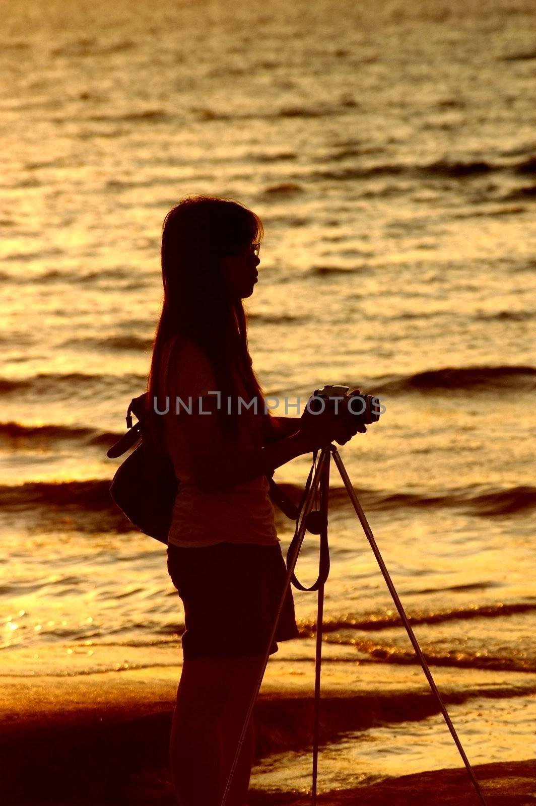 Female photographer under sunset