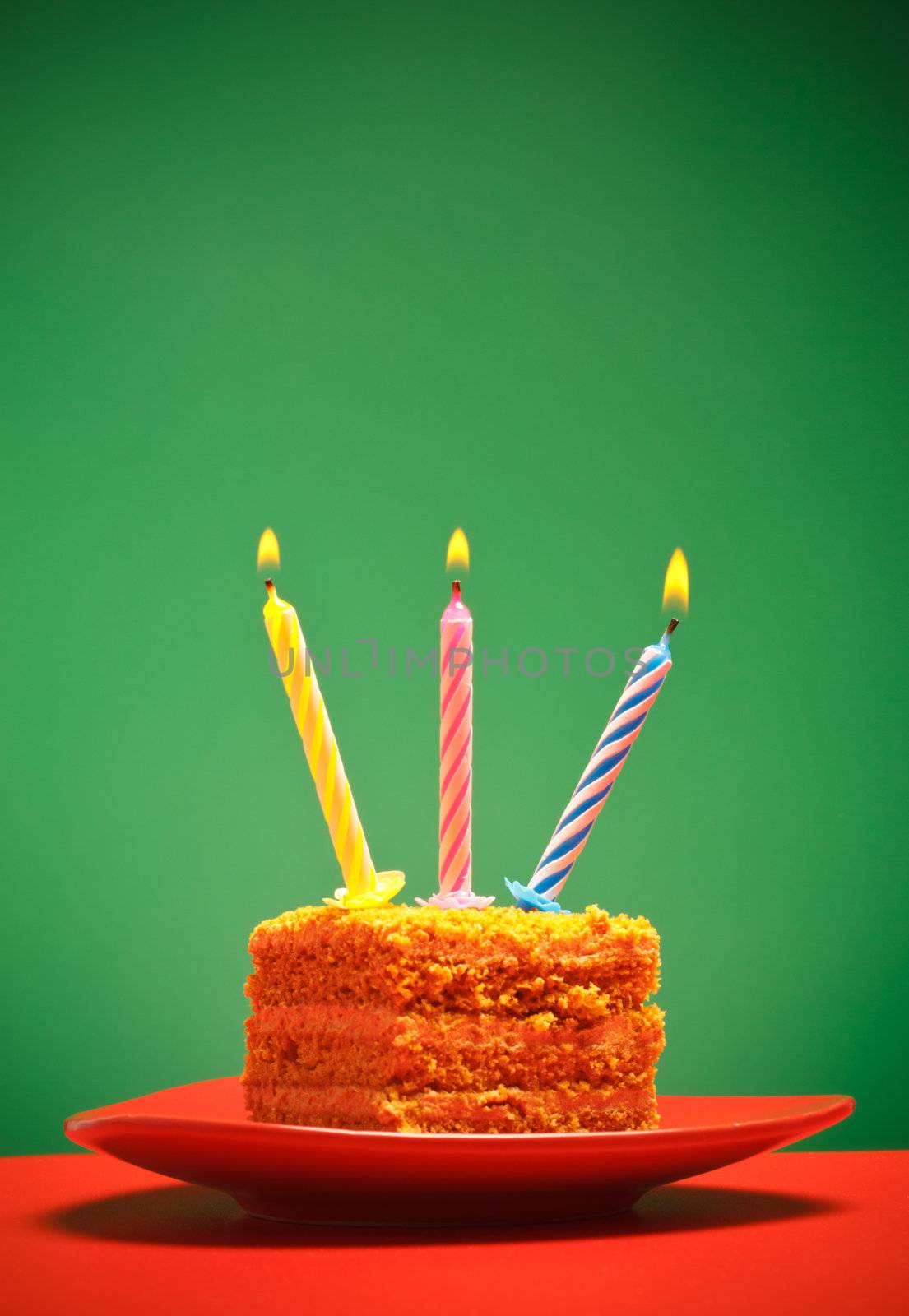 birthday cake with candle on pink background