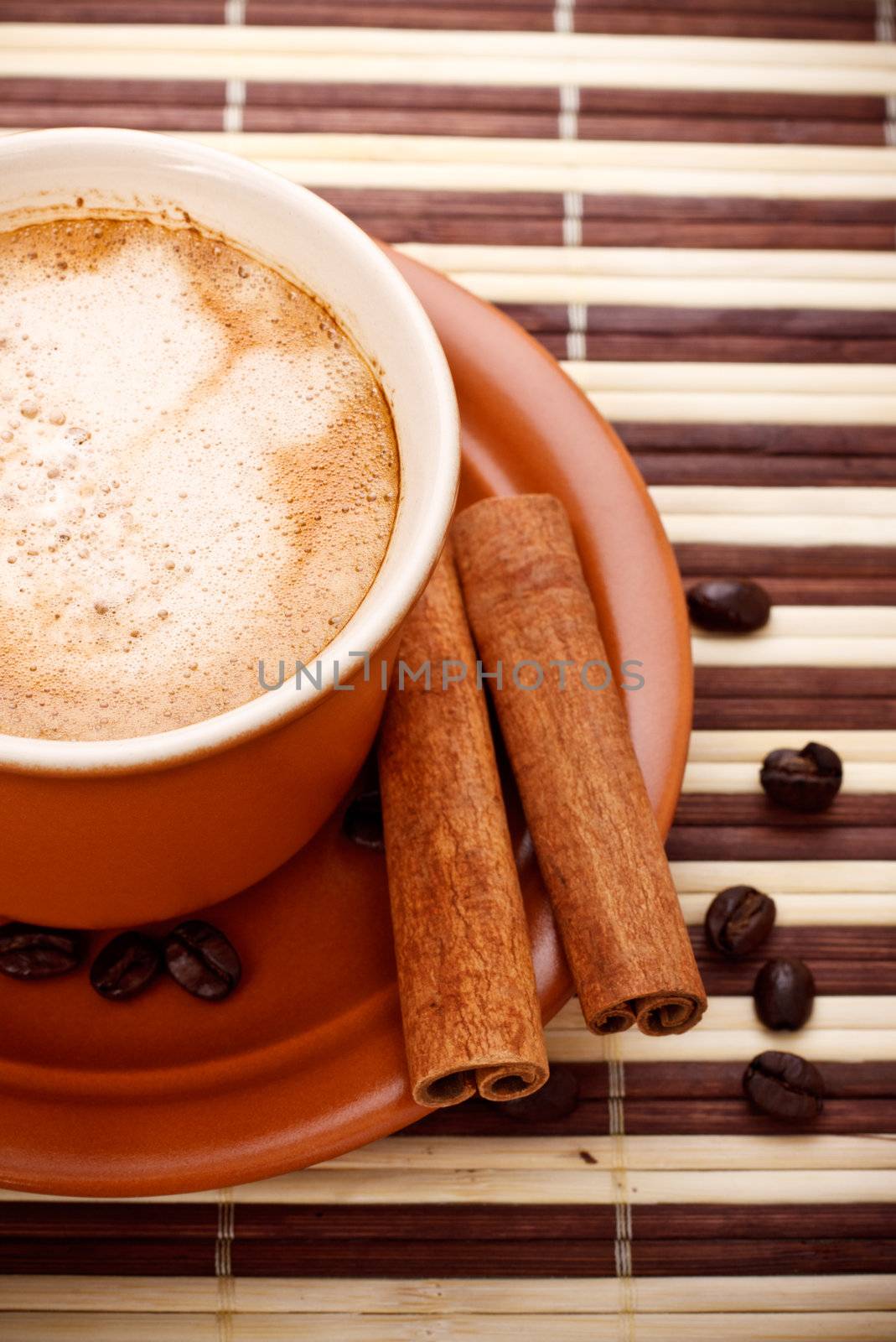 fresh coffee cup and beans on bamboo napkin