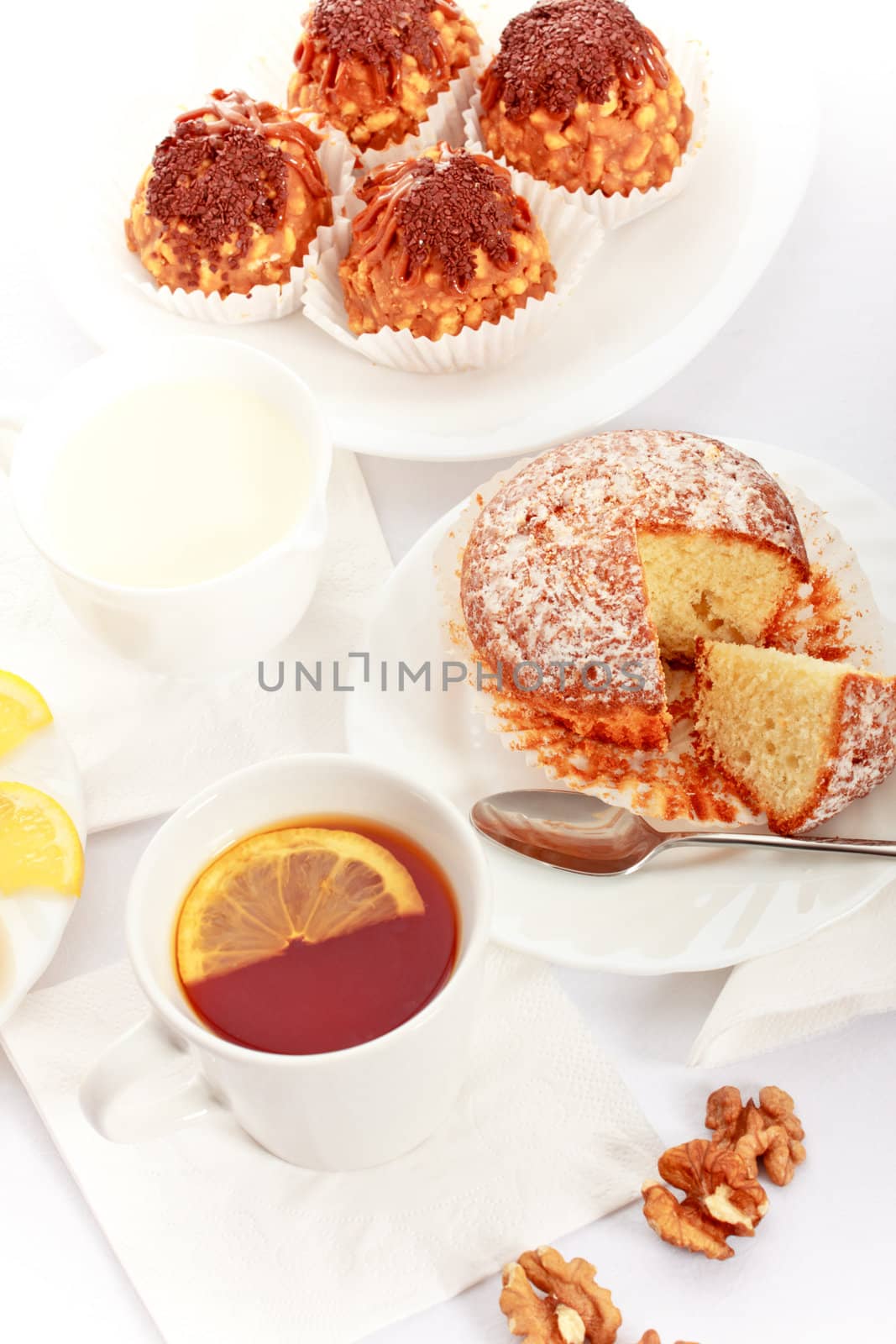 tea with lemon and fancy cakes, still life
