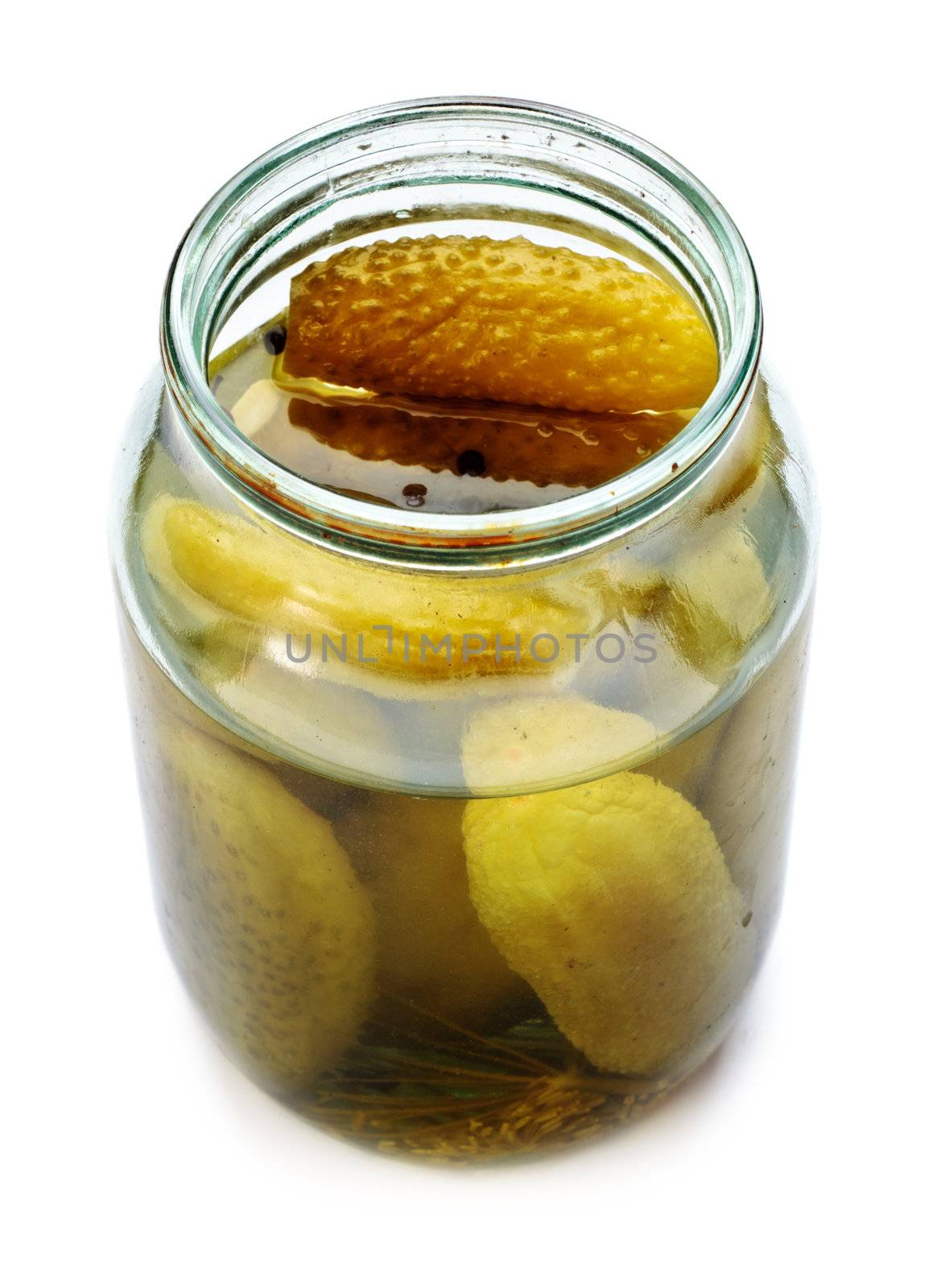 opened glass jar of green pickled cucumbers