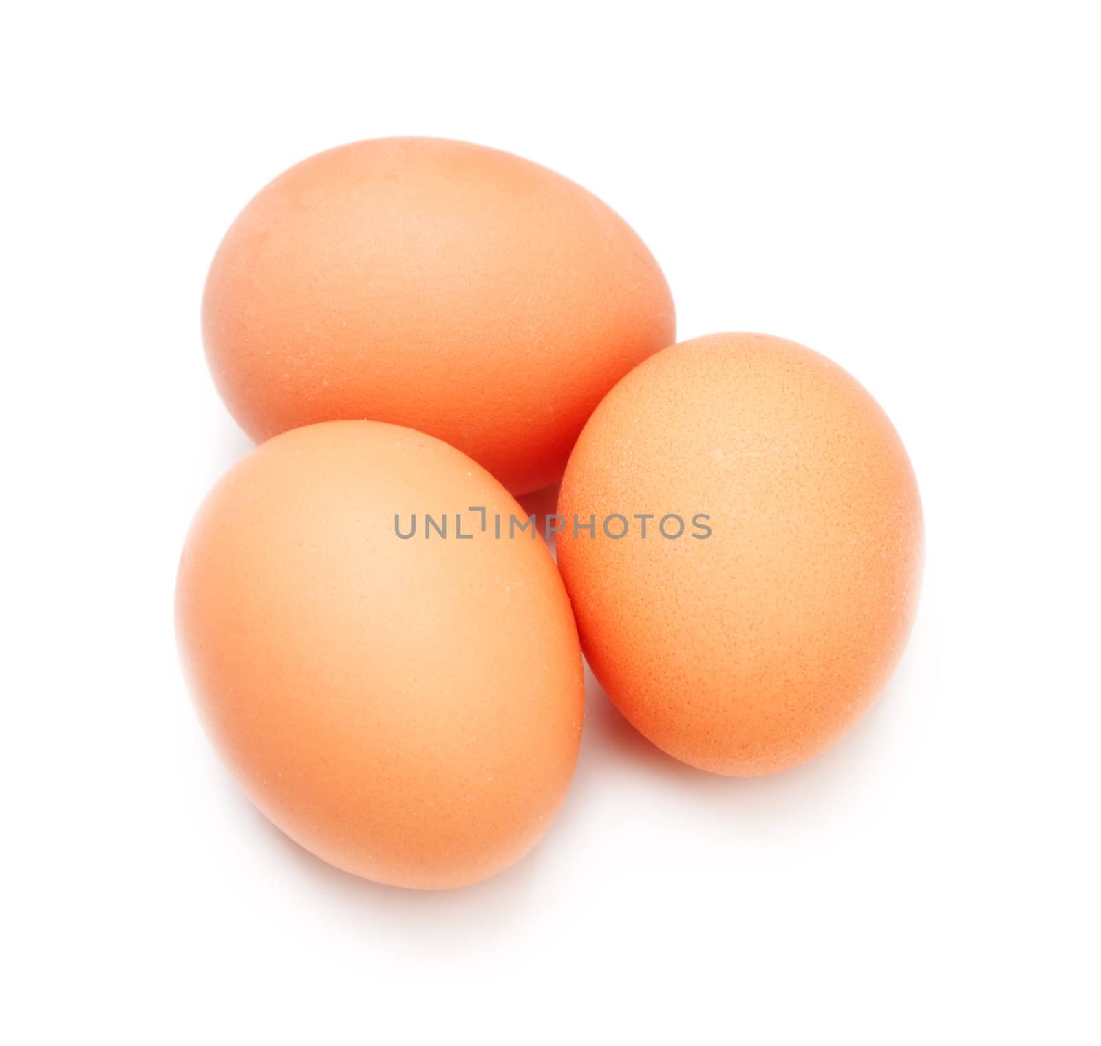 three brown eggs isolated on white background