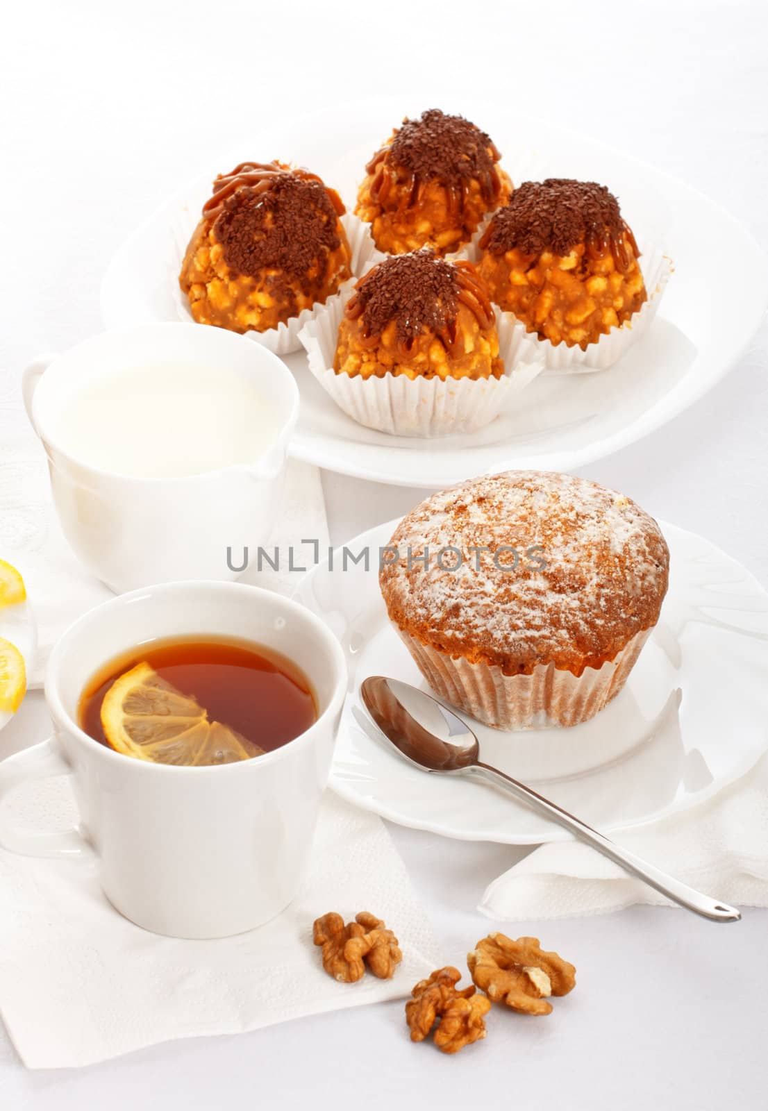 tea with lemon and fancy cakes, still life