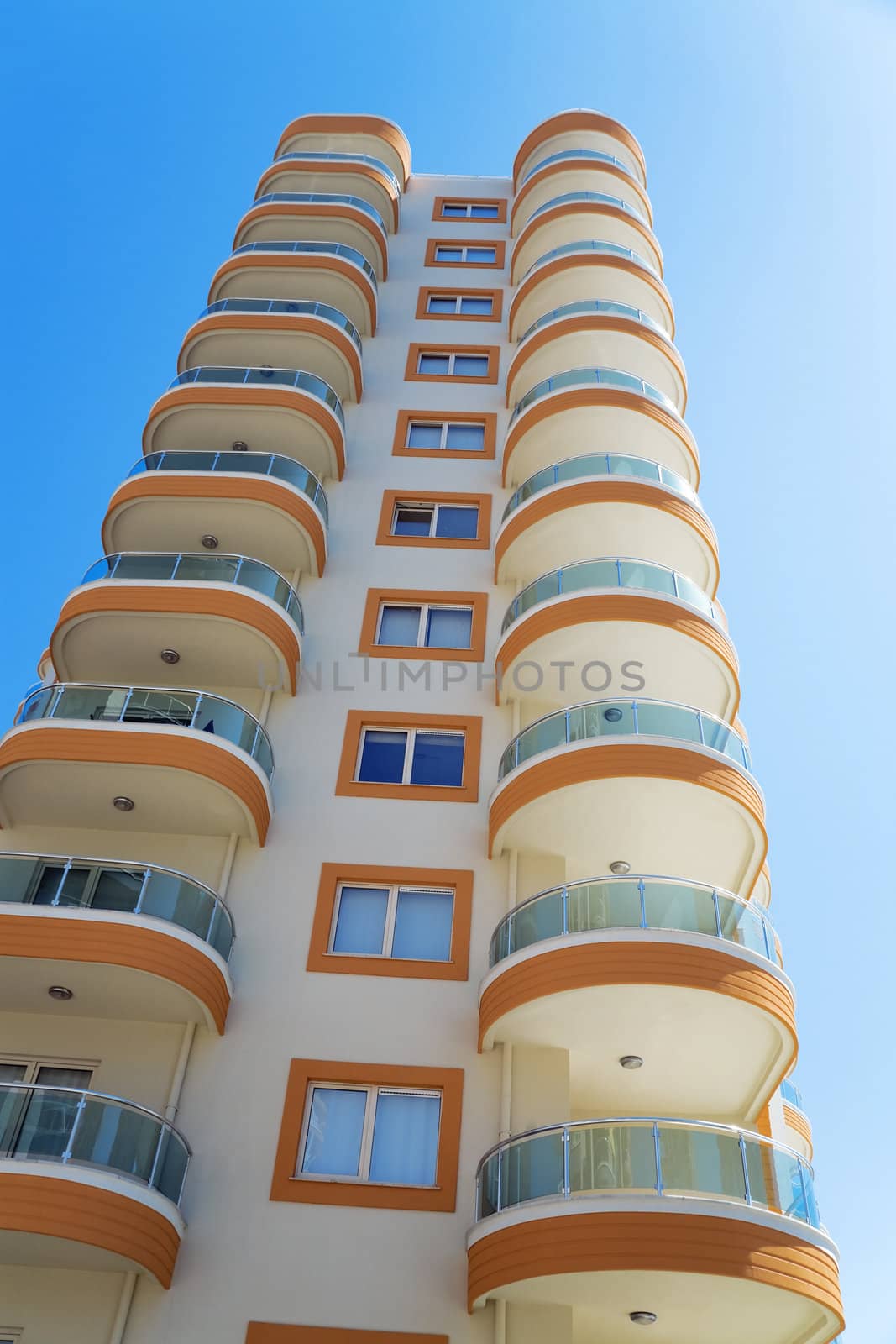 high modern residential building on a background blue sky