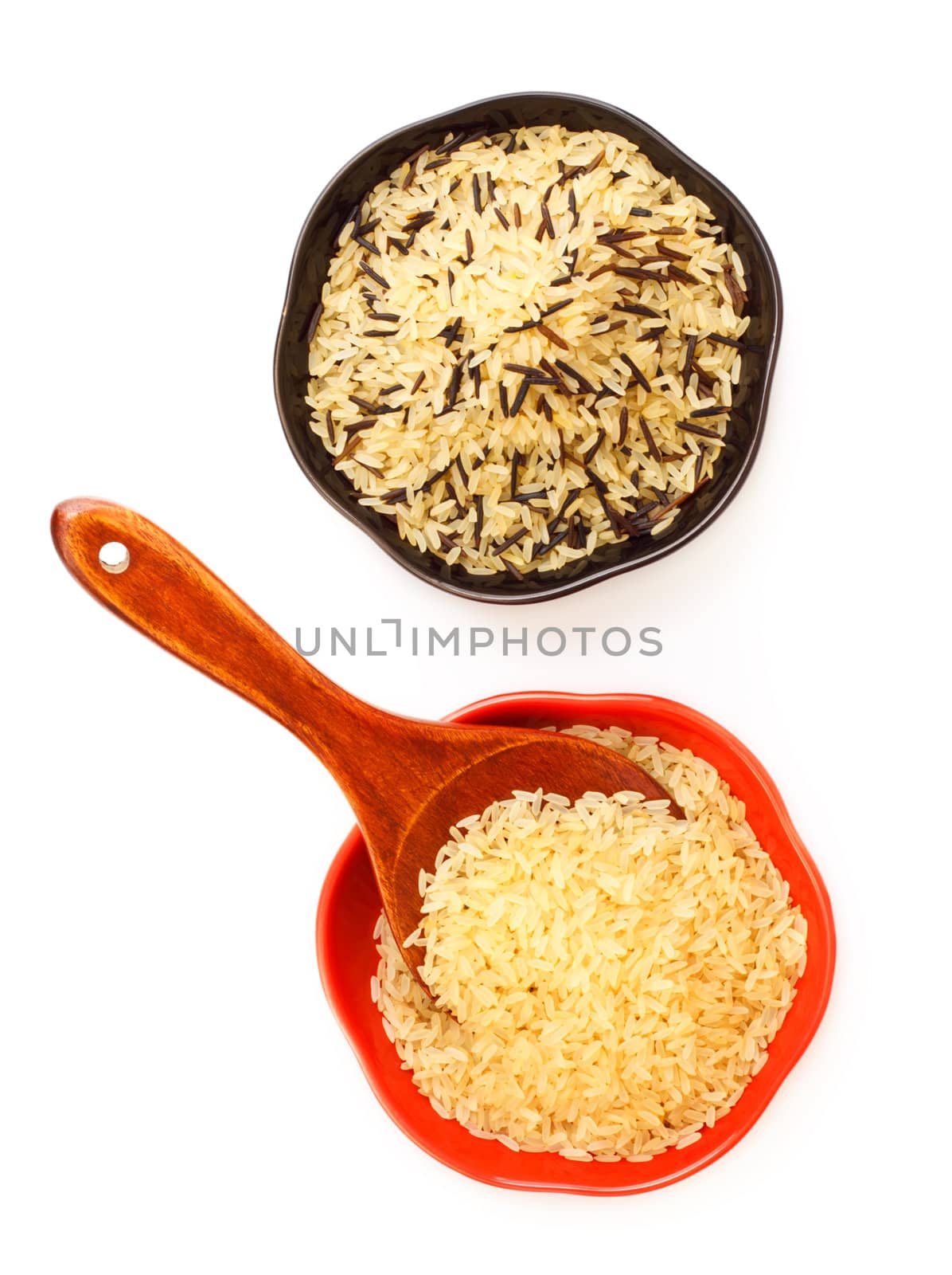 two bowls with rice and wooden spoon