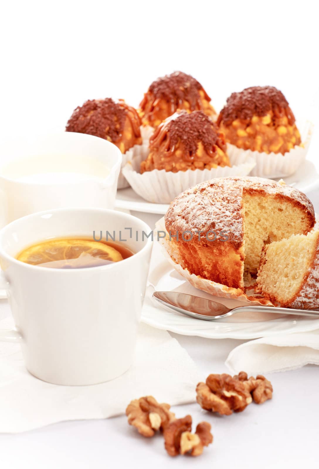 tea with lemon and fancy cakes, still life