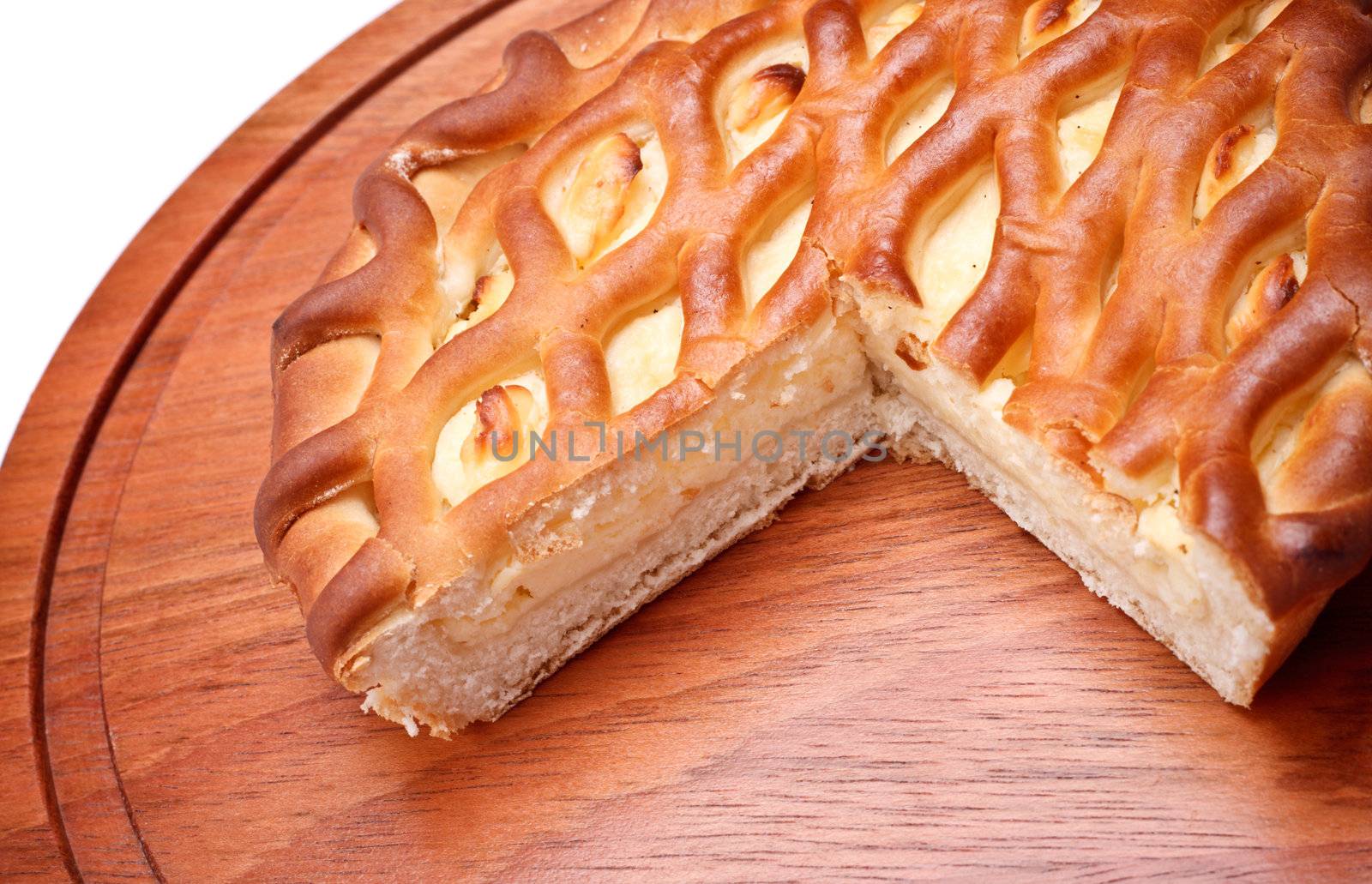 pie with curds on wooden tray, isolated on white