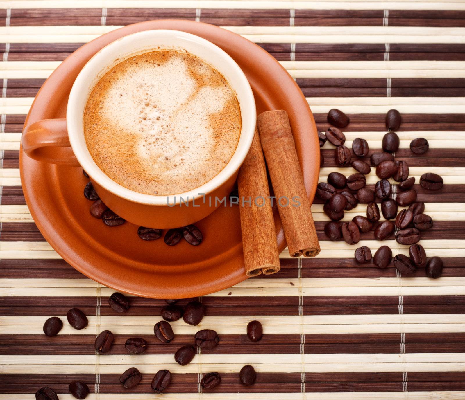 fresh coffee cup and beans on bamboo napkin