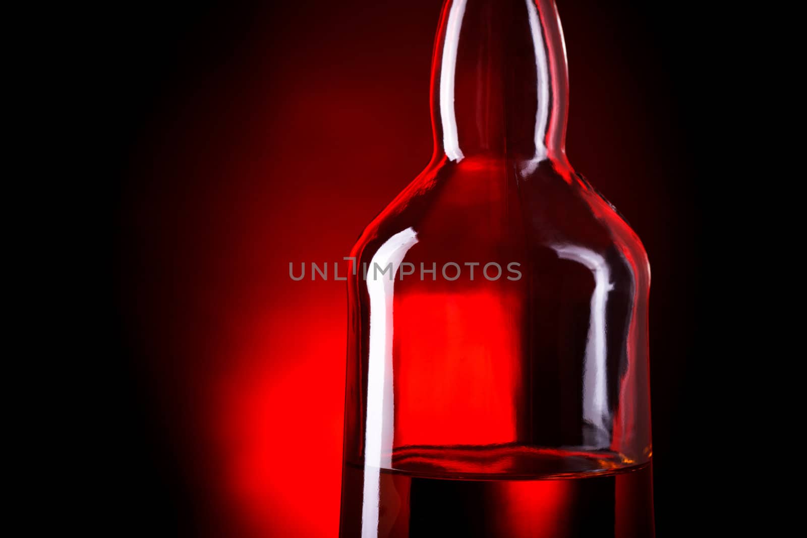 bottle of whiskey on deep red background
