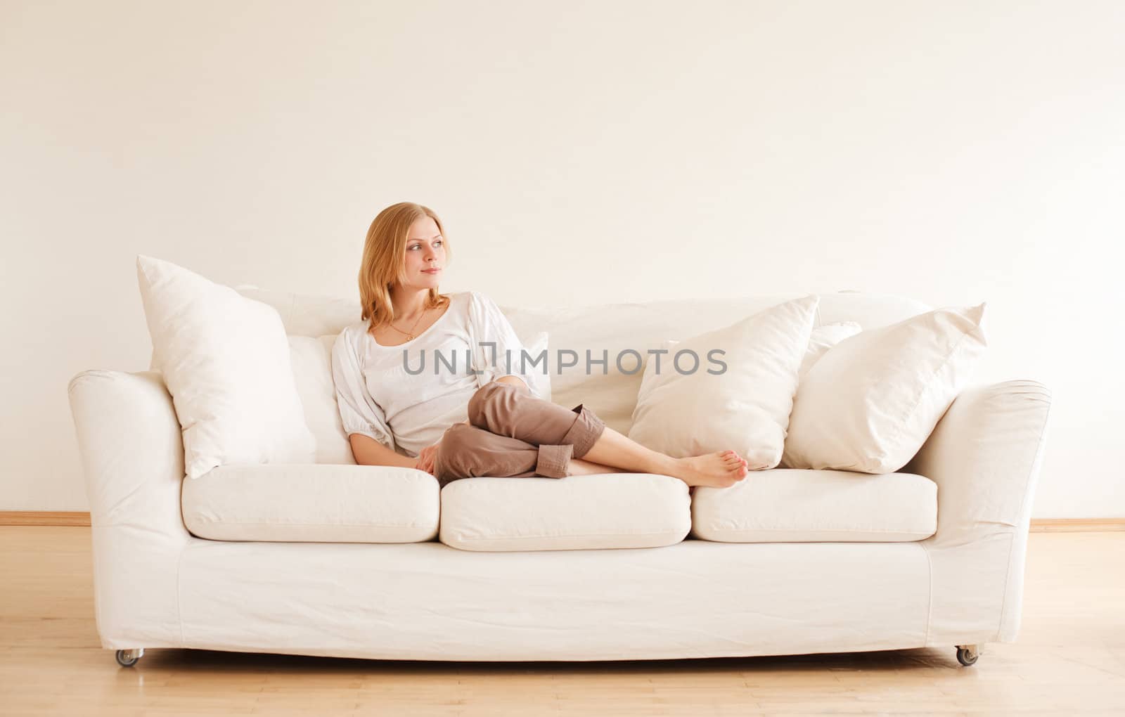 cute young girl relaxing on couch at home