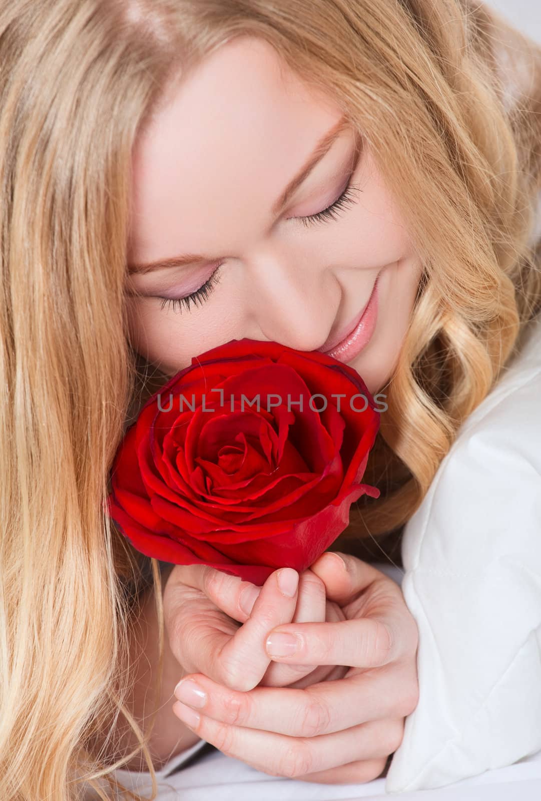 portrait of pretty smiling woman with red rose