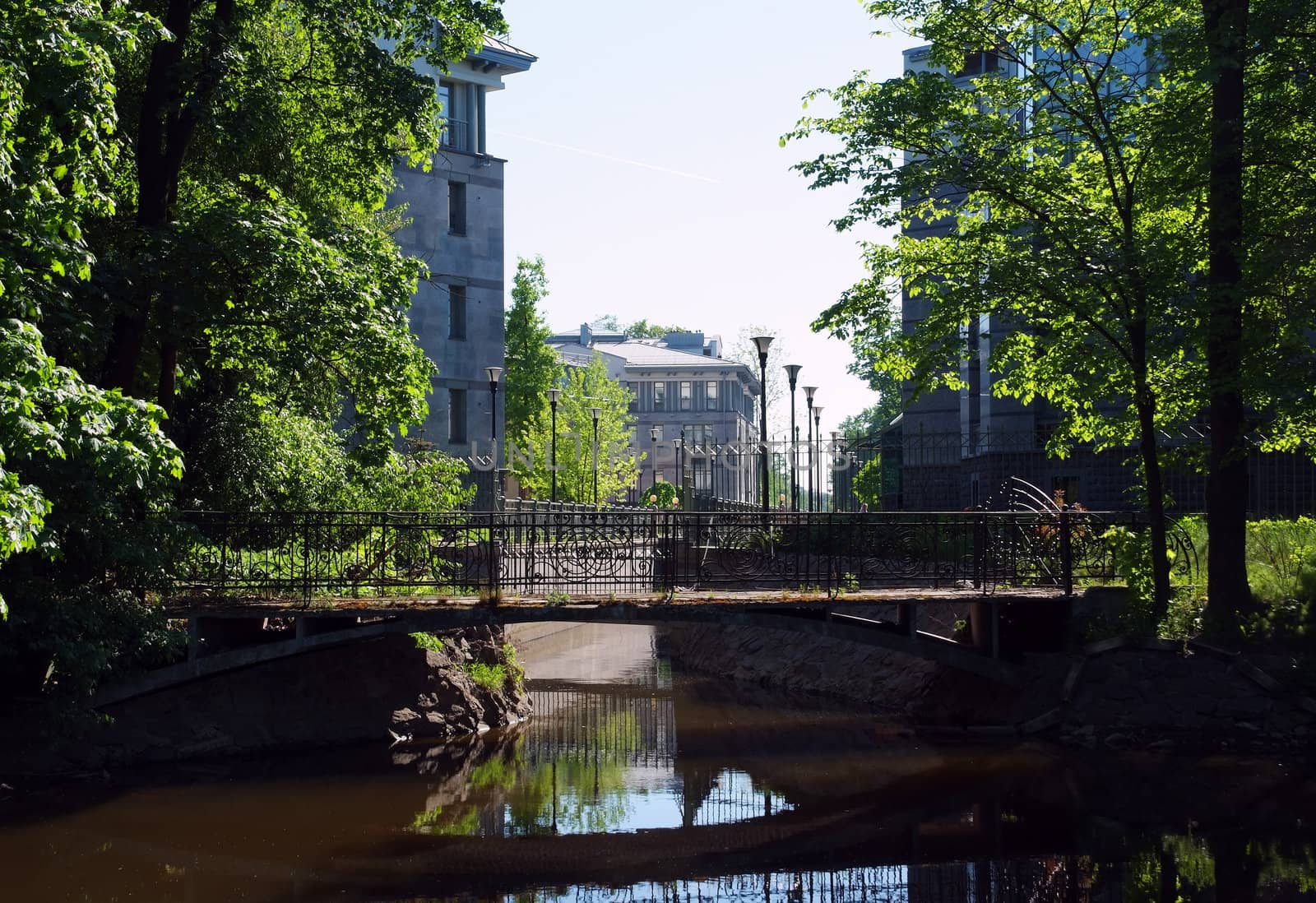 Street with houses over water canal and old bridge